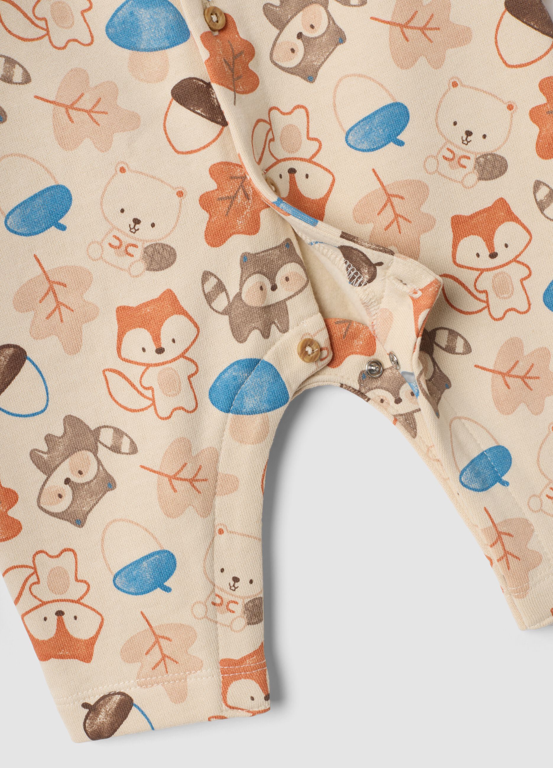 Beige organic cotton sleepsuit with animal print