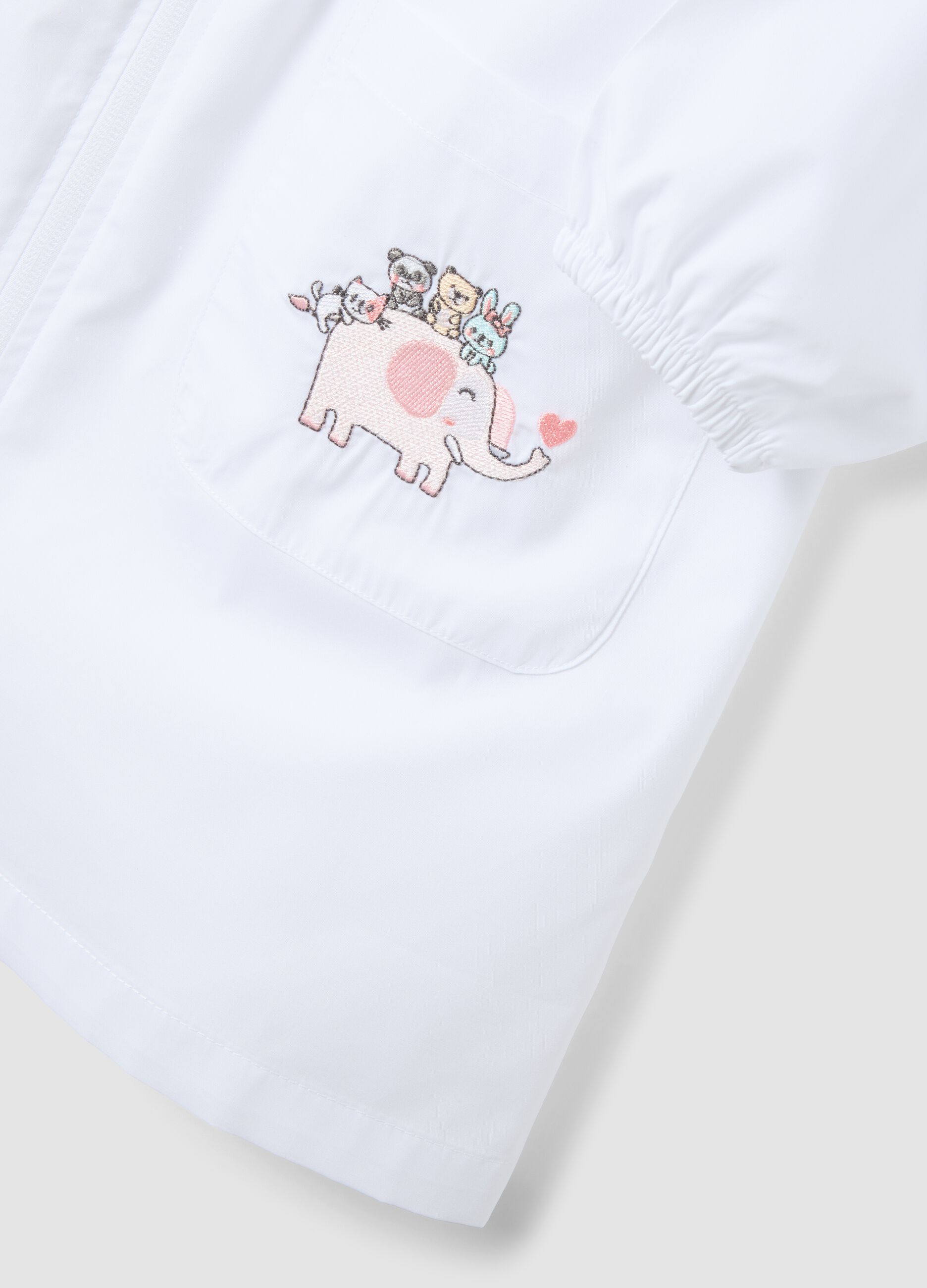 Customisable white nursery apron with embroidered animals