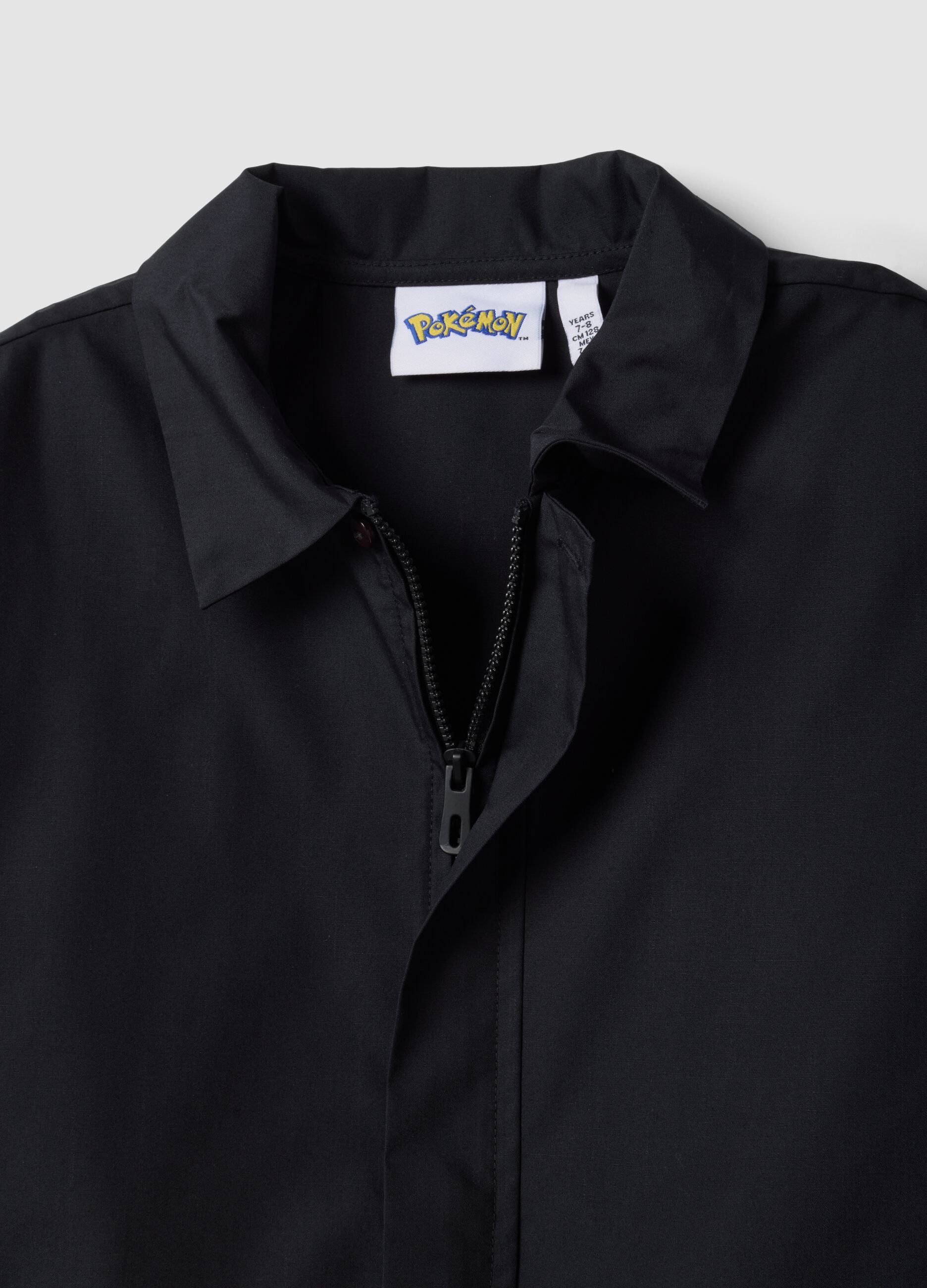 Black zip-up Pok&eacute;mon embroidered school apron for boys