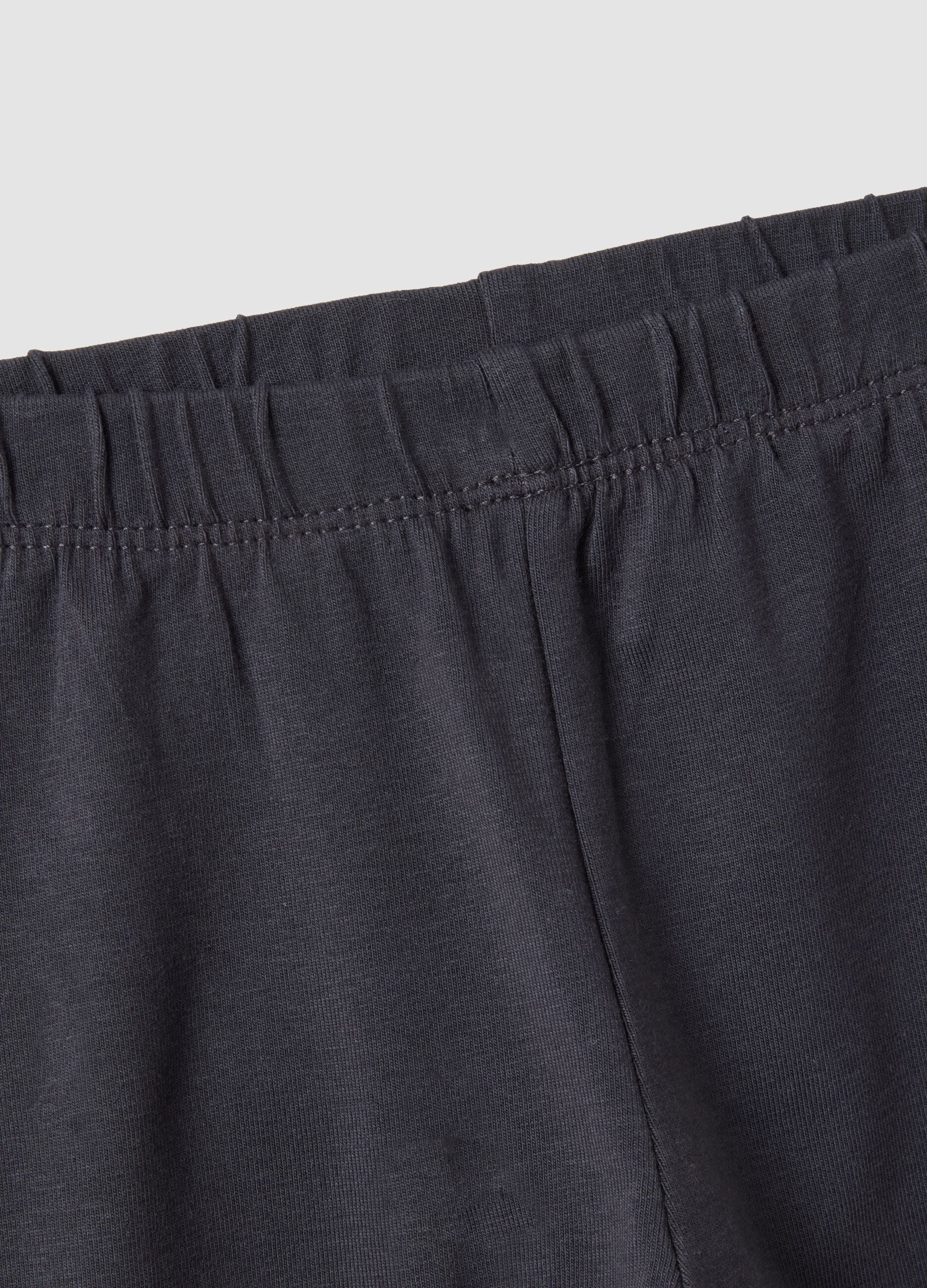 Black flared leggings in stretchy organic cotton blend with heart print for baby girl