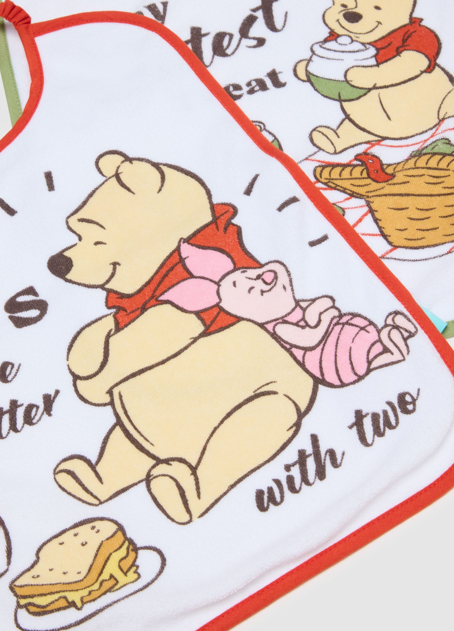 Twin-pack of white cotton mix bibs for newborn girls with Winnie the Pooh