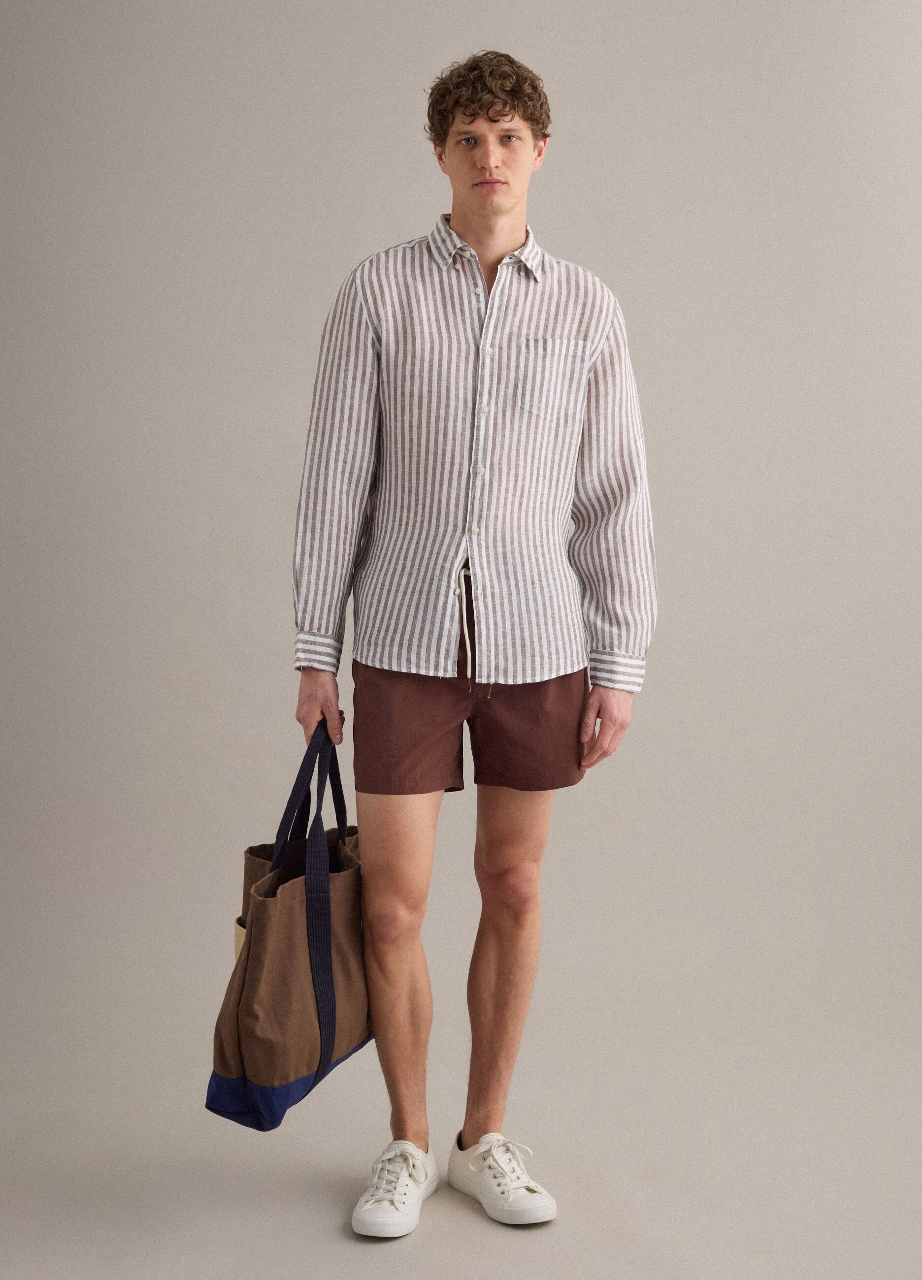 Brown swim shorts with elasticated waistband and drawstring