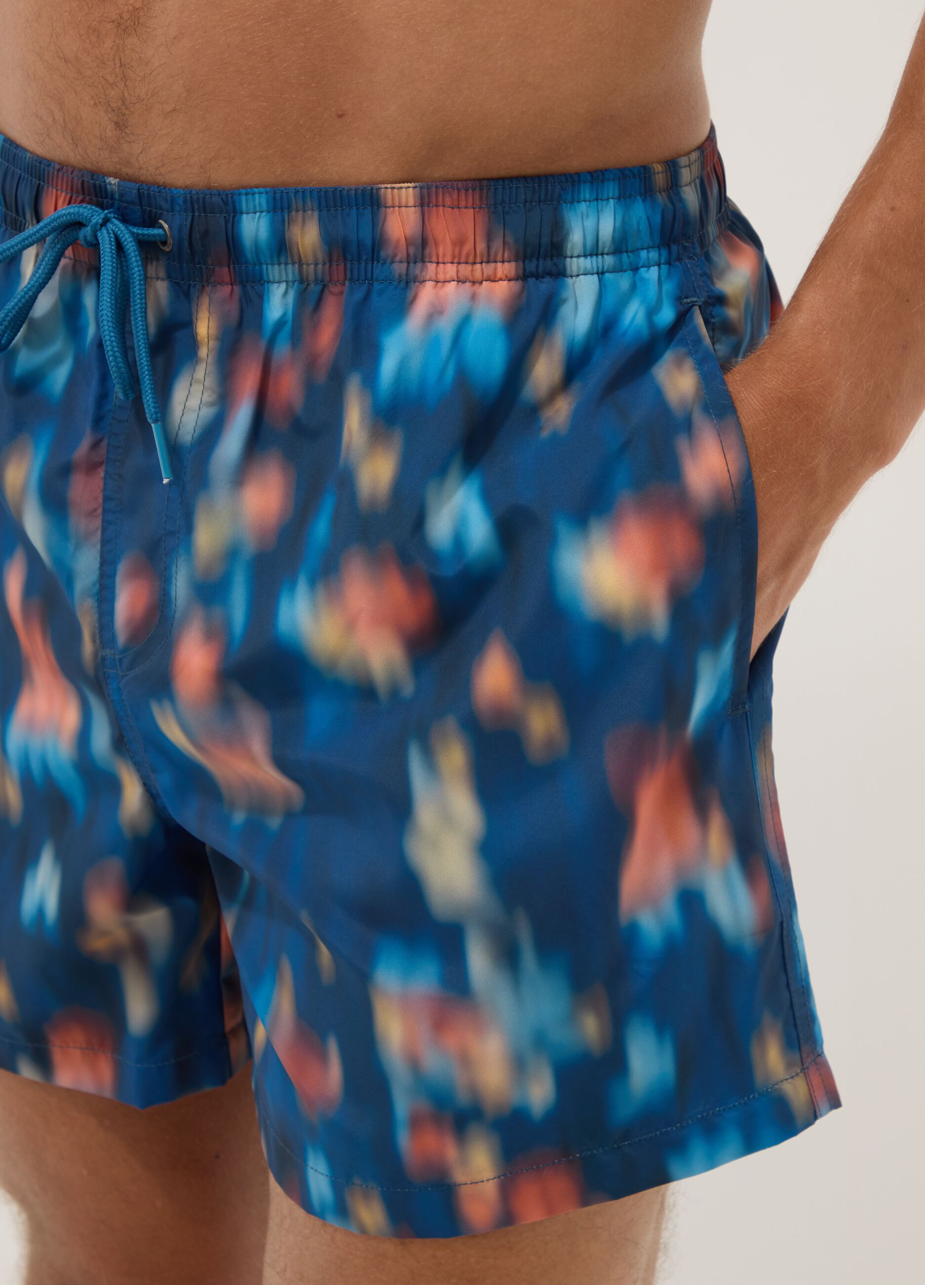 Blue boxer swim shorts with multicolour gradient print