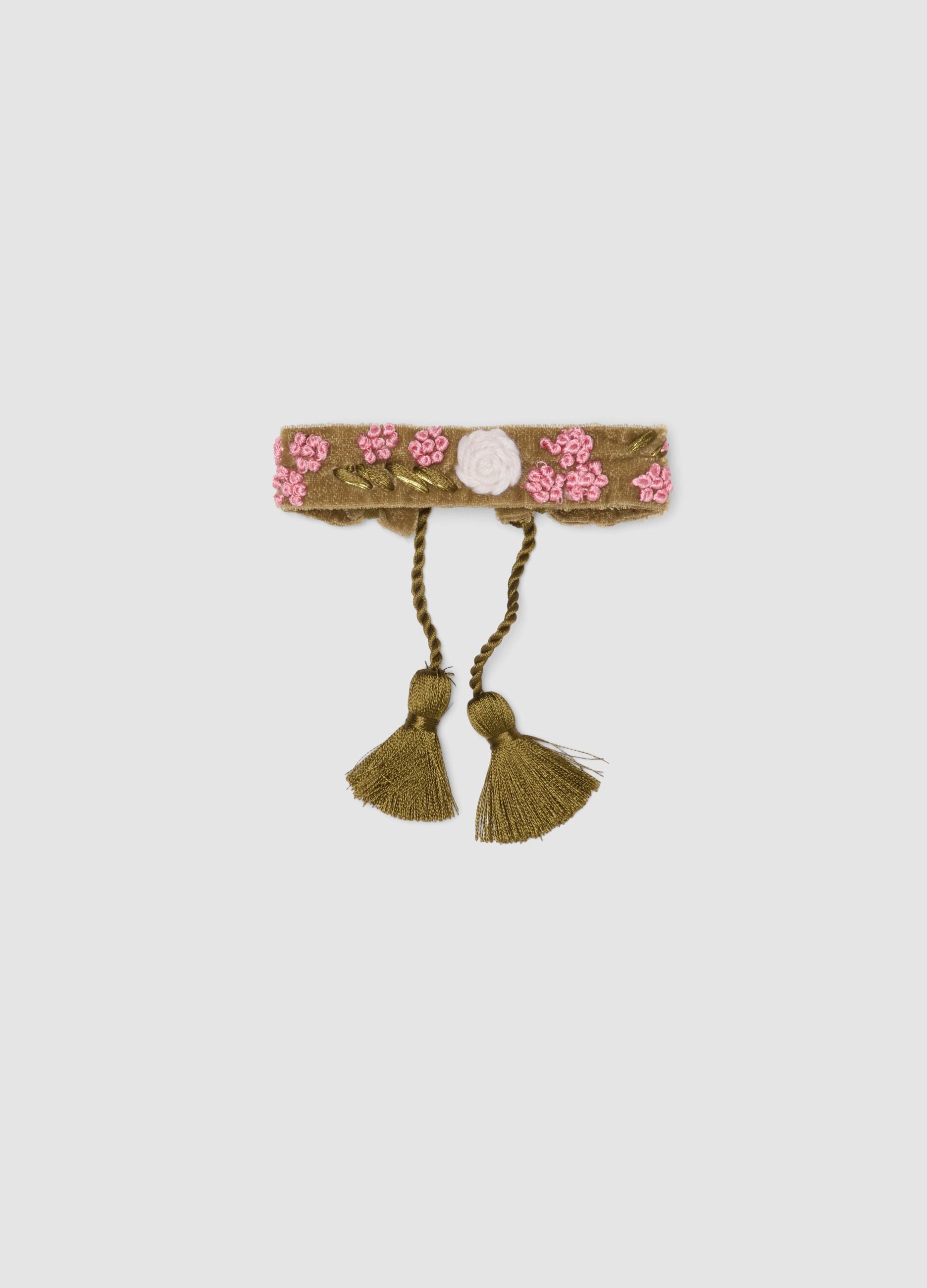 Green bracelet with embroidered flowers and tassels