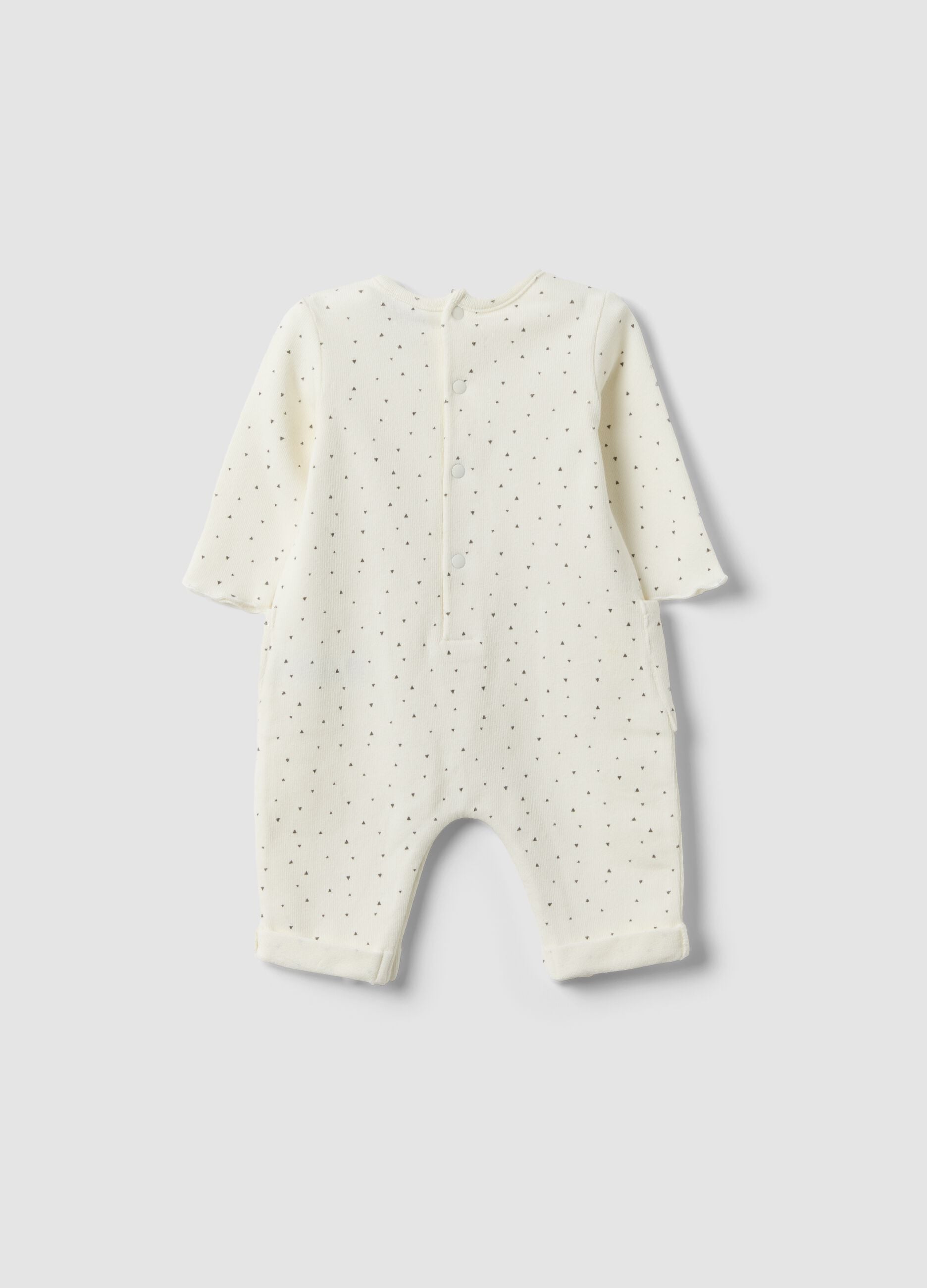 White organic cotton baby romper with buttons and pattern