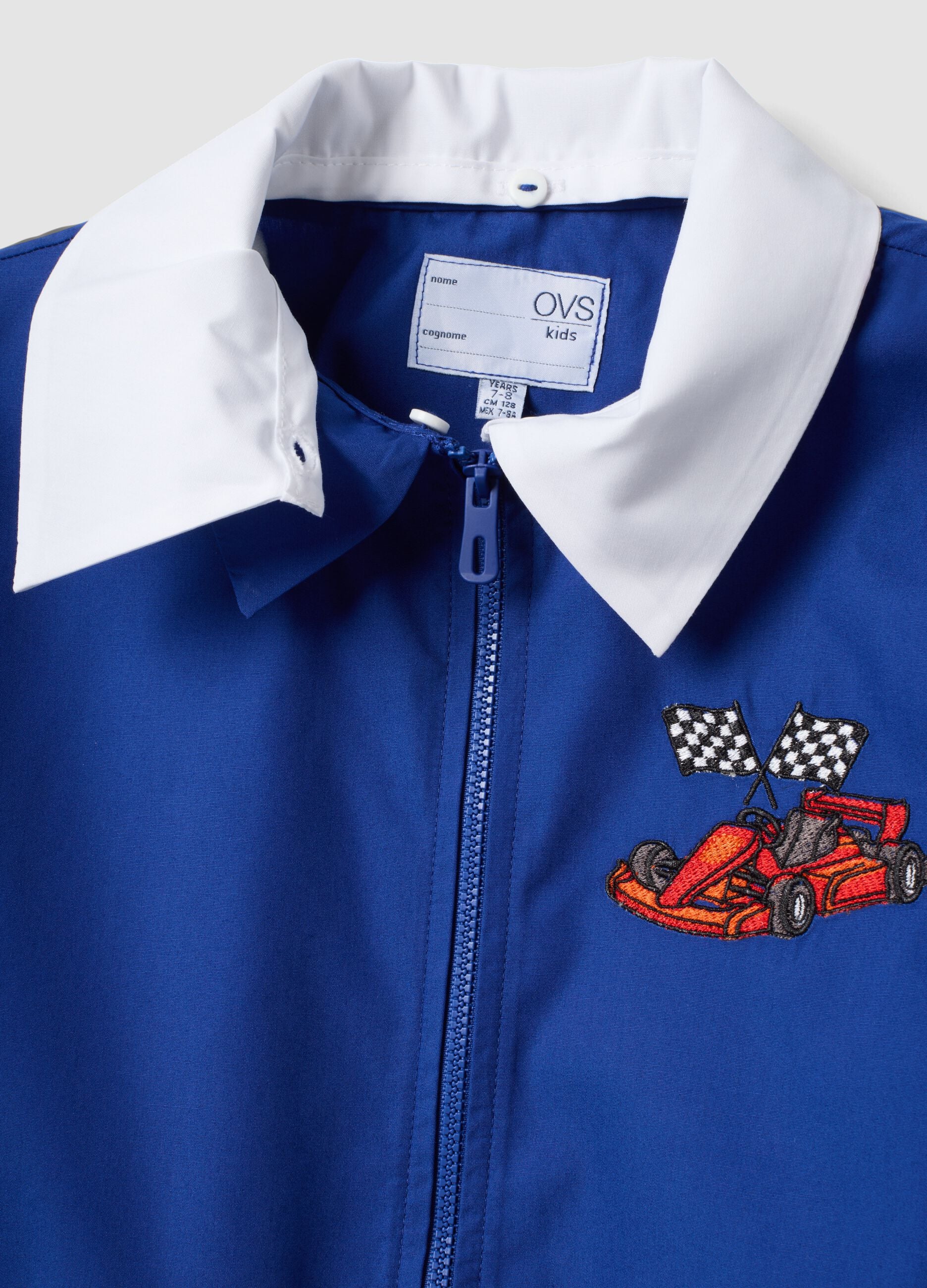 Customisable blue school apron with zip and go-kart embroidery for boys