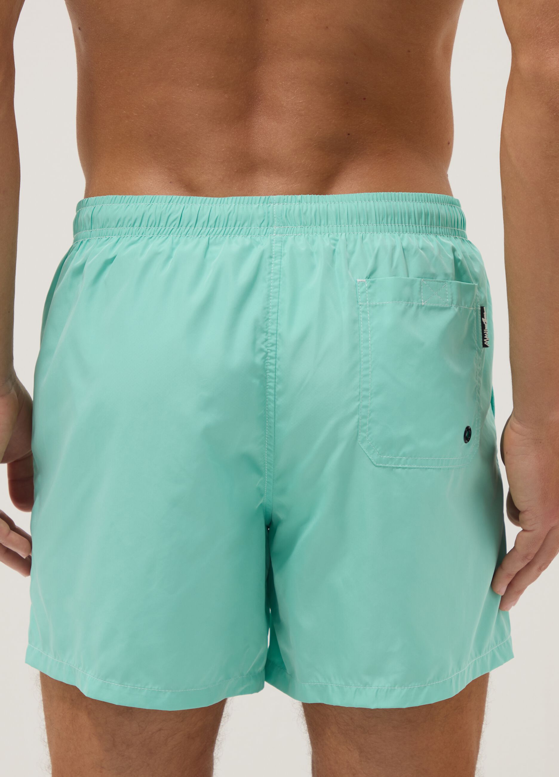 Light blue swim shorts with drawstring waist