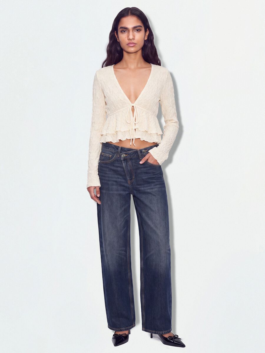White stretch top with deep V-neck and ruffle trim_1