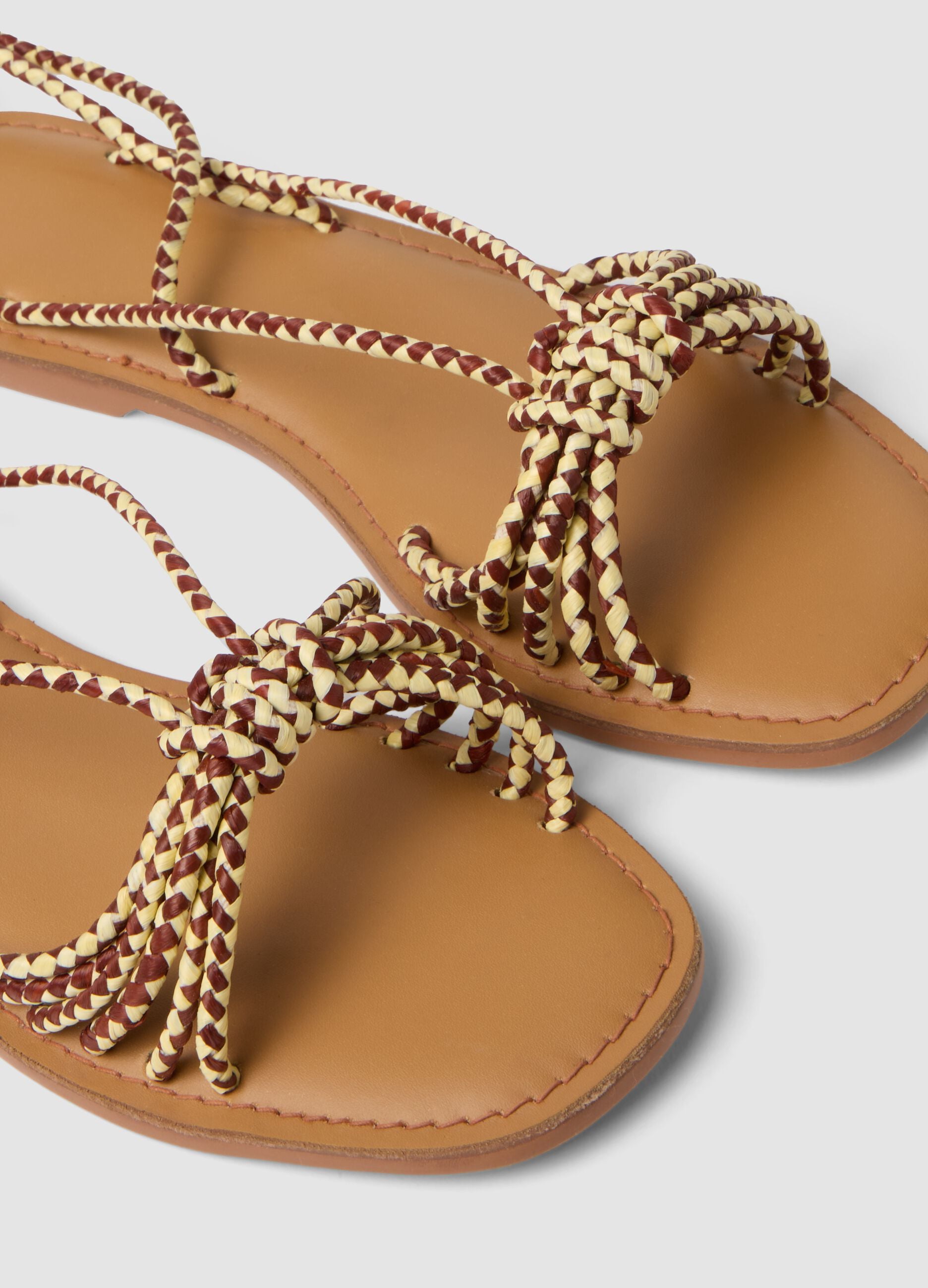 Brown flat sandals with braided tie-up straps