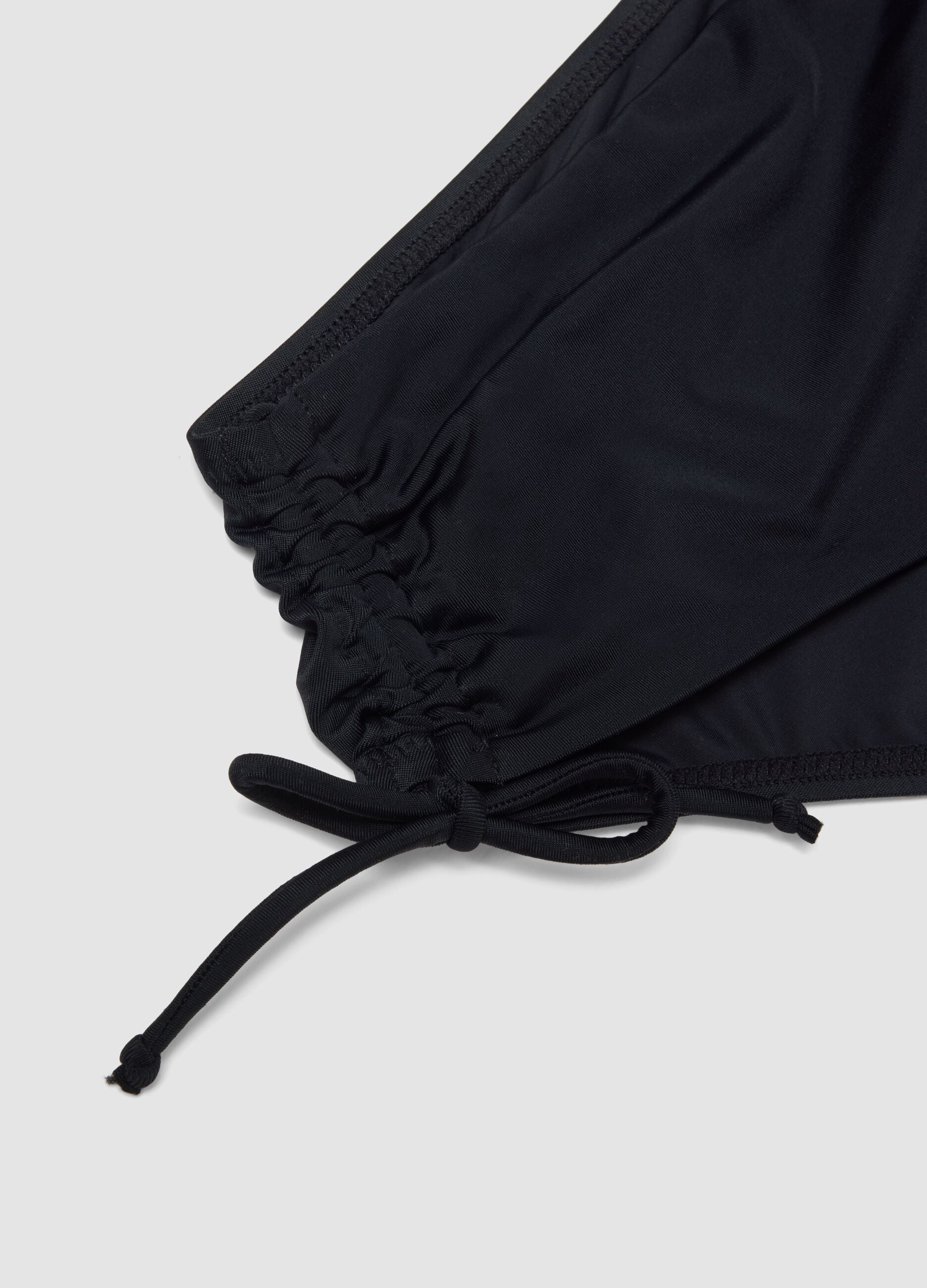 Black stretch bikini bottoms with ruched detailing