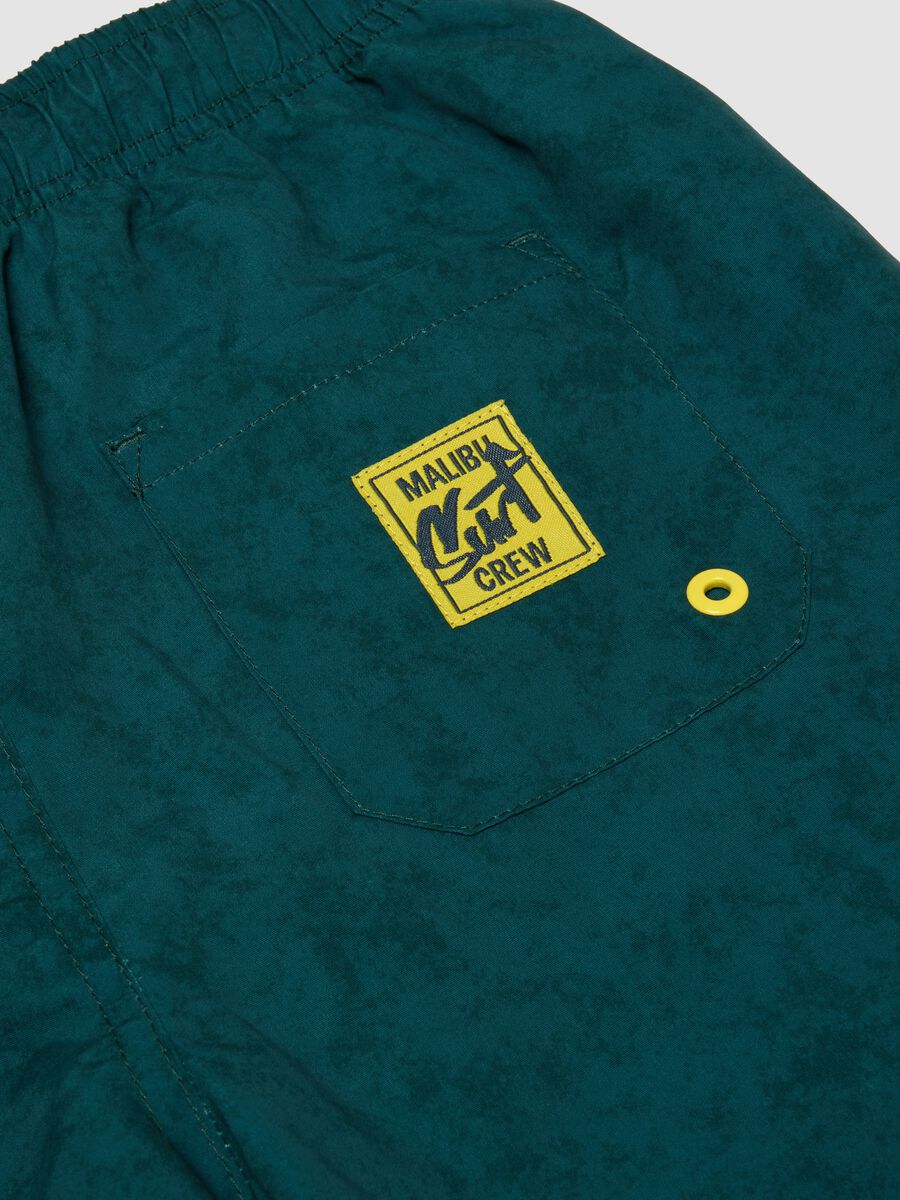 Green swim shorts with graphic print_3