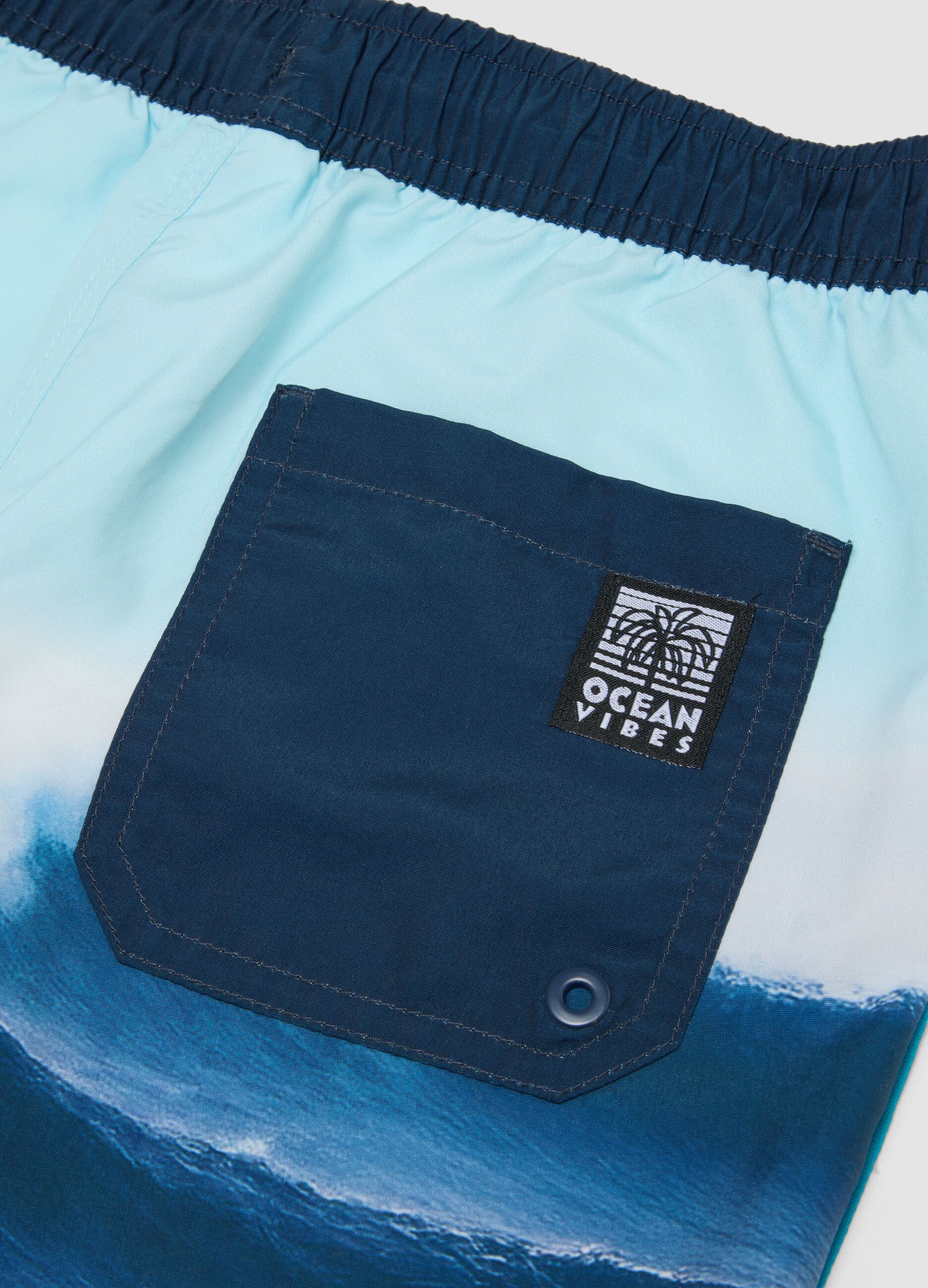 Blue boys&rsquo; swim shorts with wave print