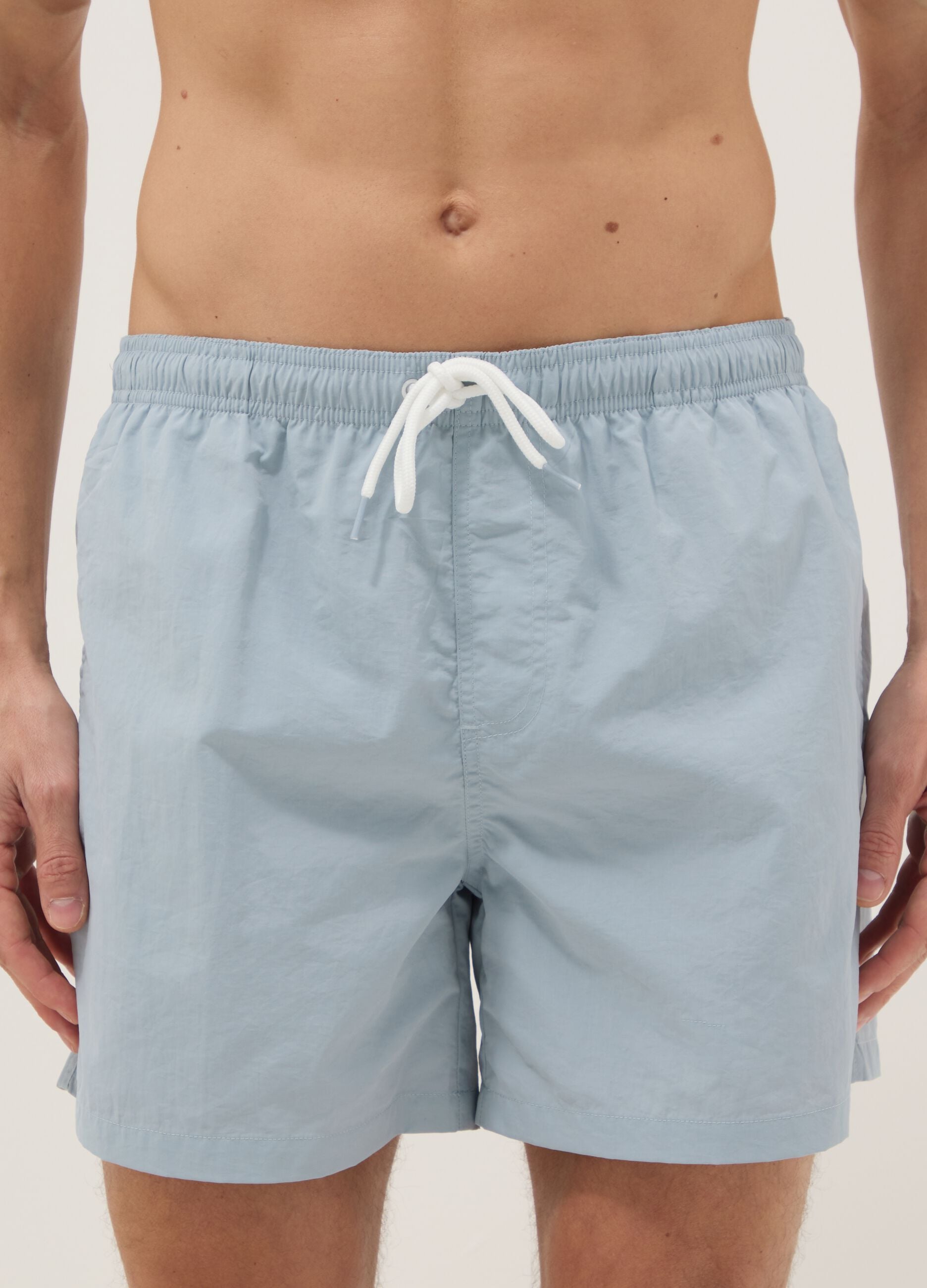 Blue swim shorts with elasticated waistband