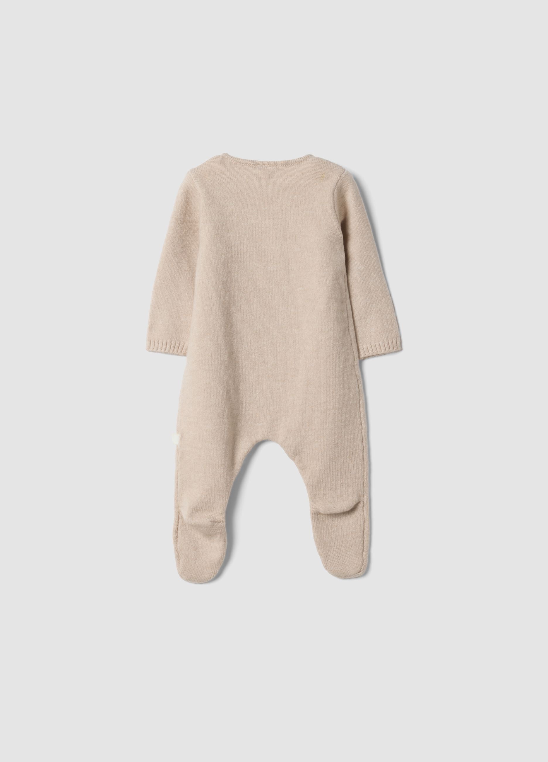 Beige baby sleepsuit with feet and wrap closure