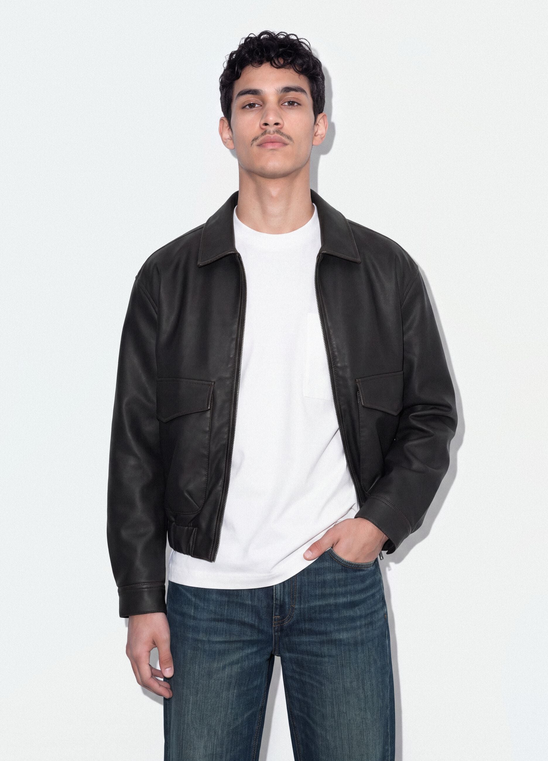 Black cropped jacket with zip and flap pockets, oversized fit