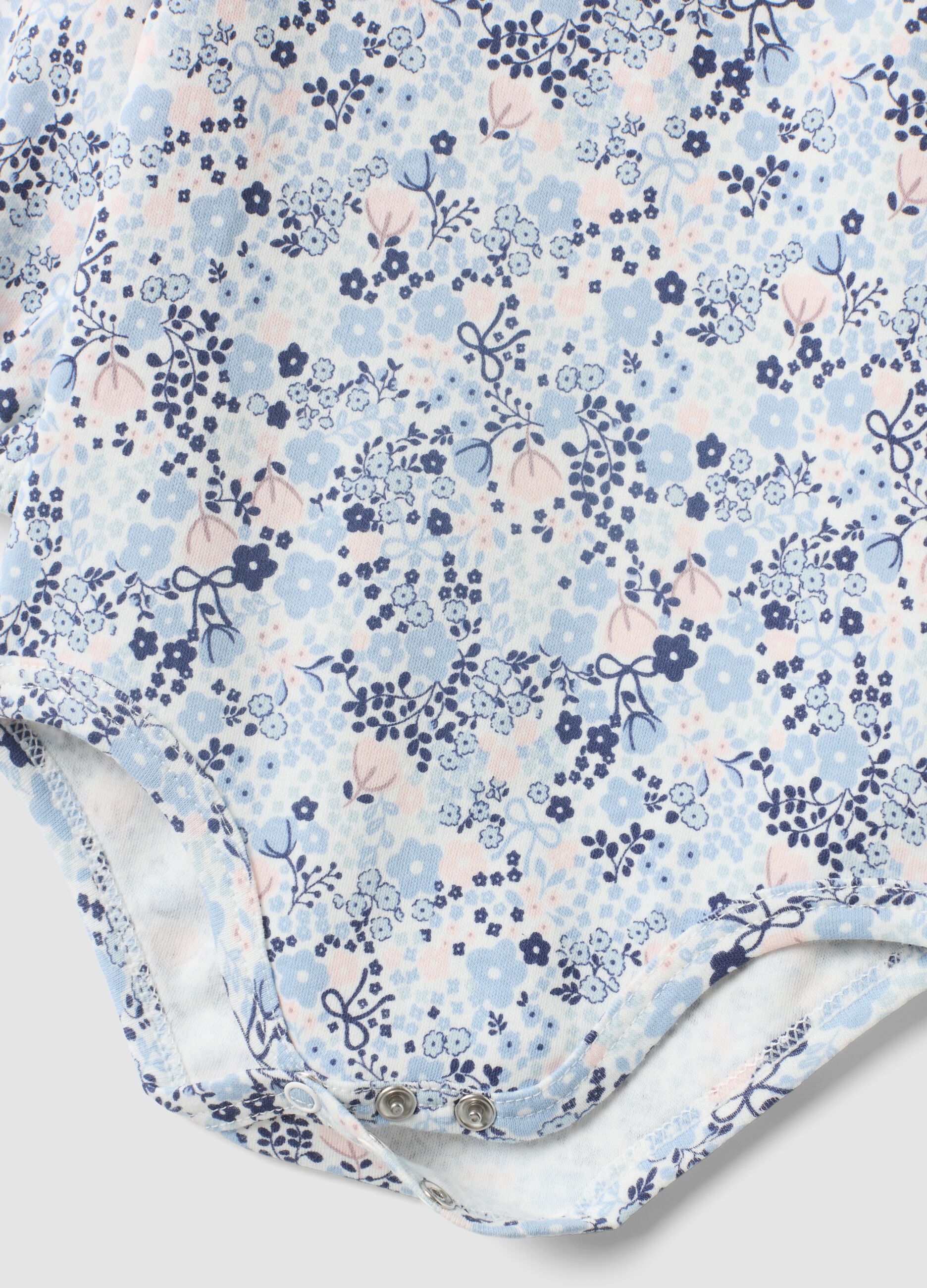 White organic cotton baby girl bodysuit with frill collar and floral print
