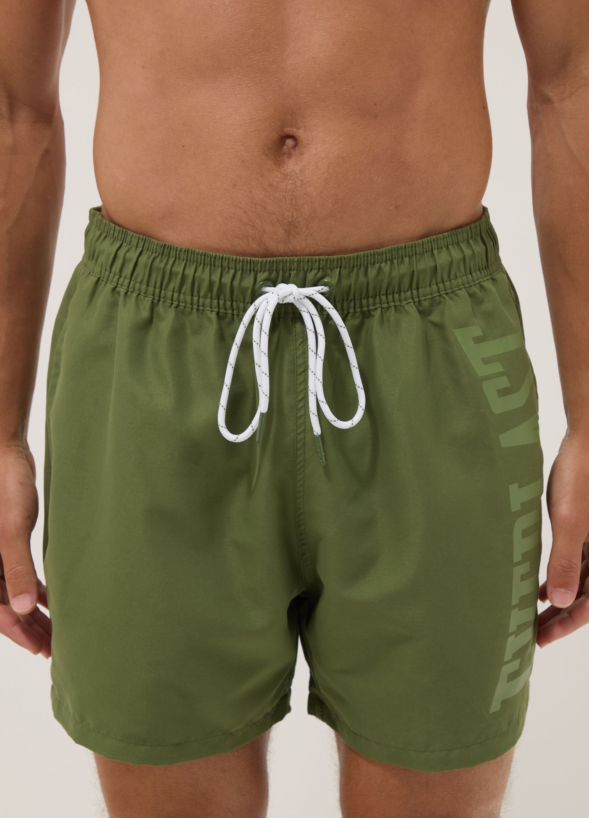 Green swim shorts with contrast drawstring