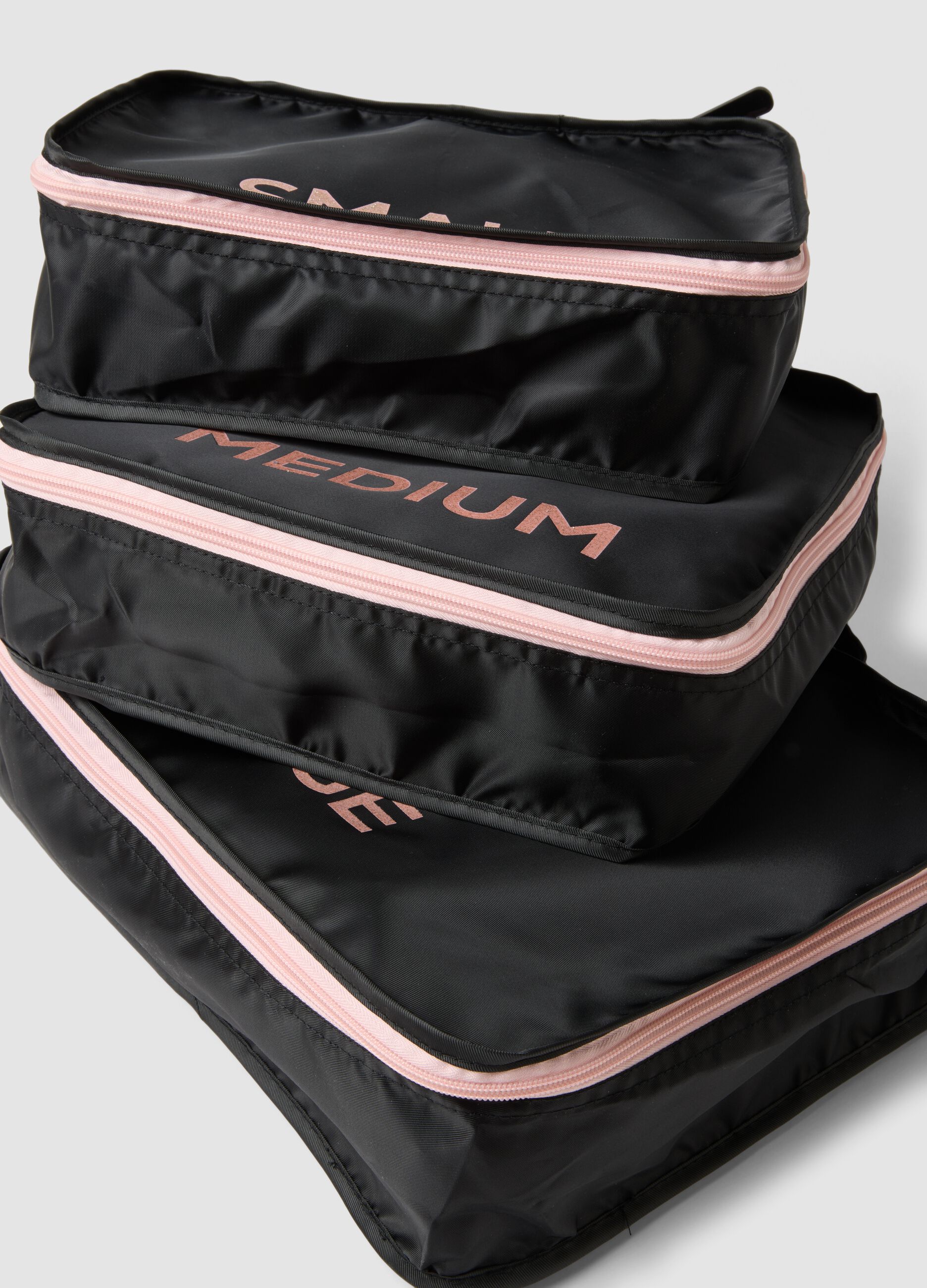 Set of three black travel organisers with pink zip