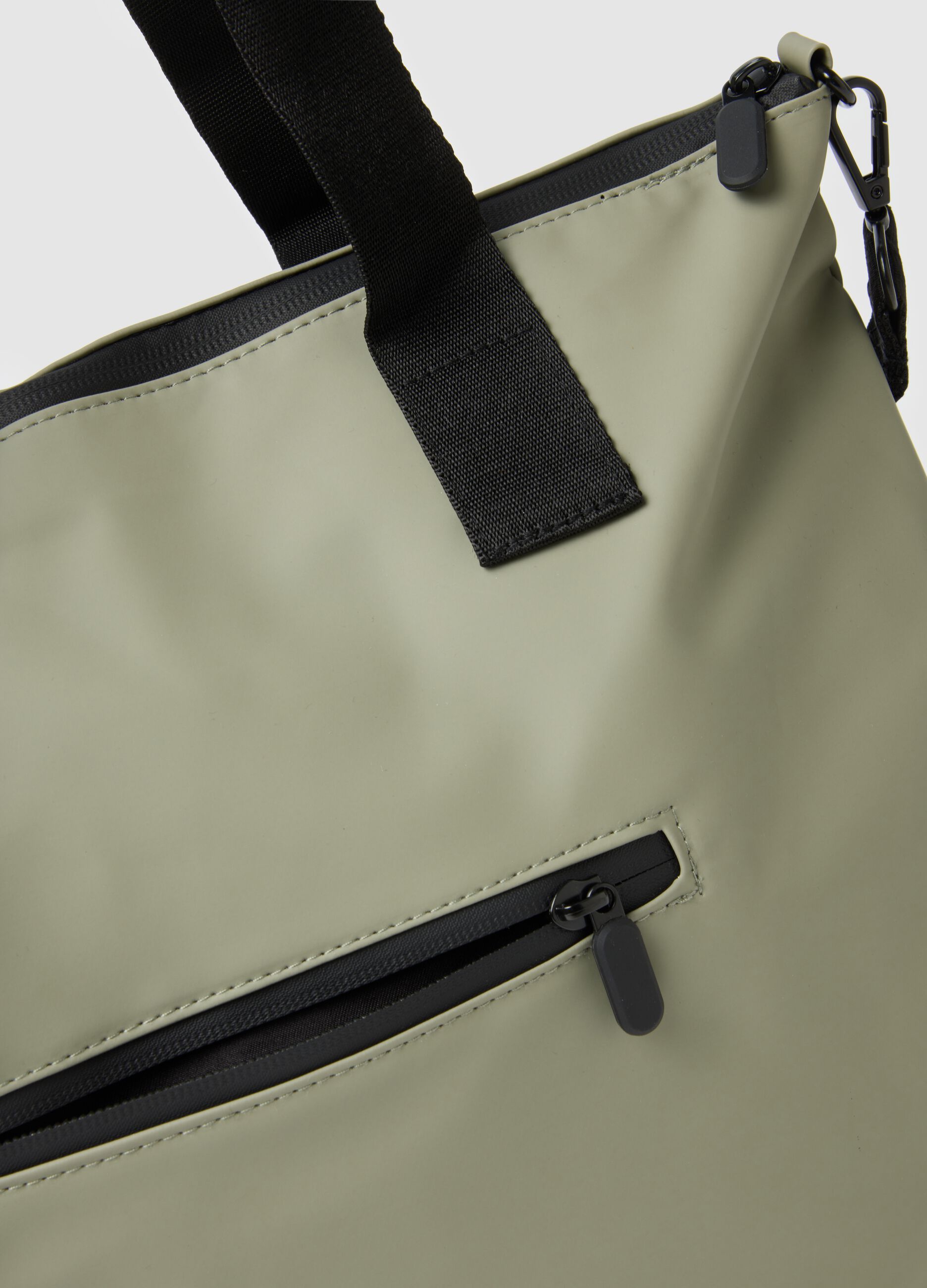 Green tote bag with multiple compartments and adjustable shoulder strap