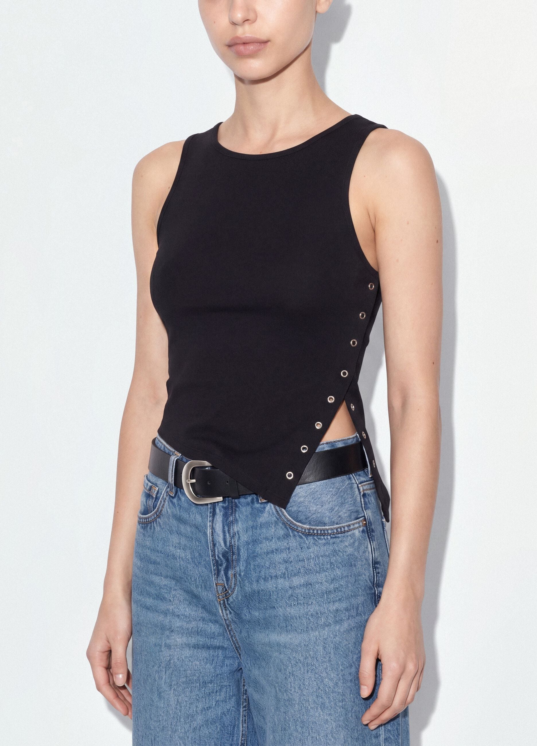 Black stretch cotton top with asymmetric hem and metal eyelets