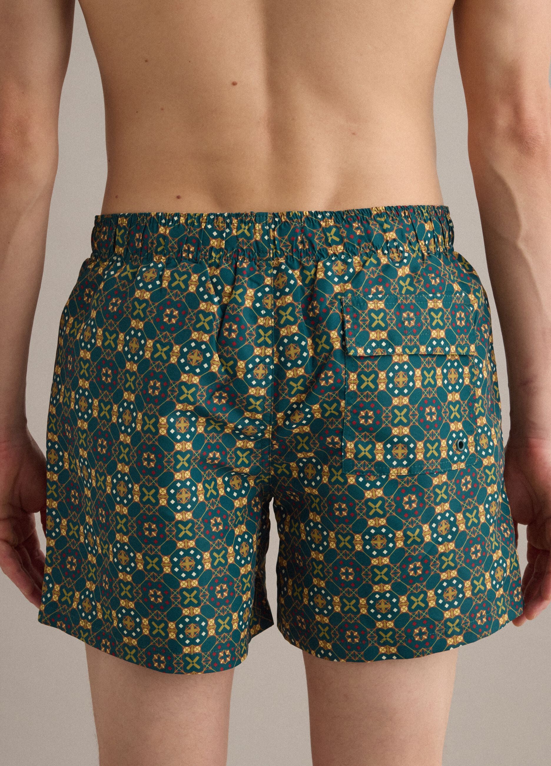 Green patterned swim shorts with elasticated waist