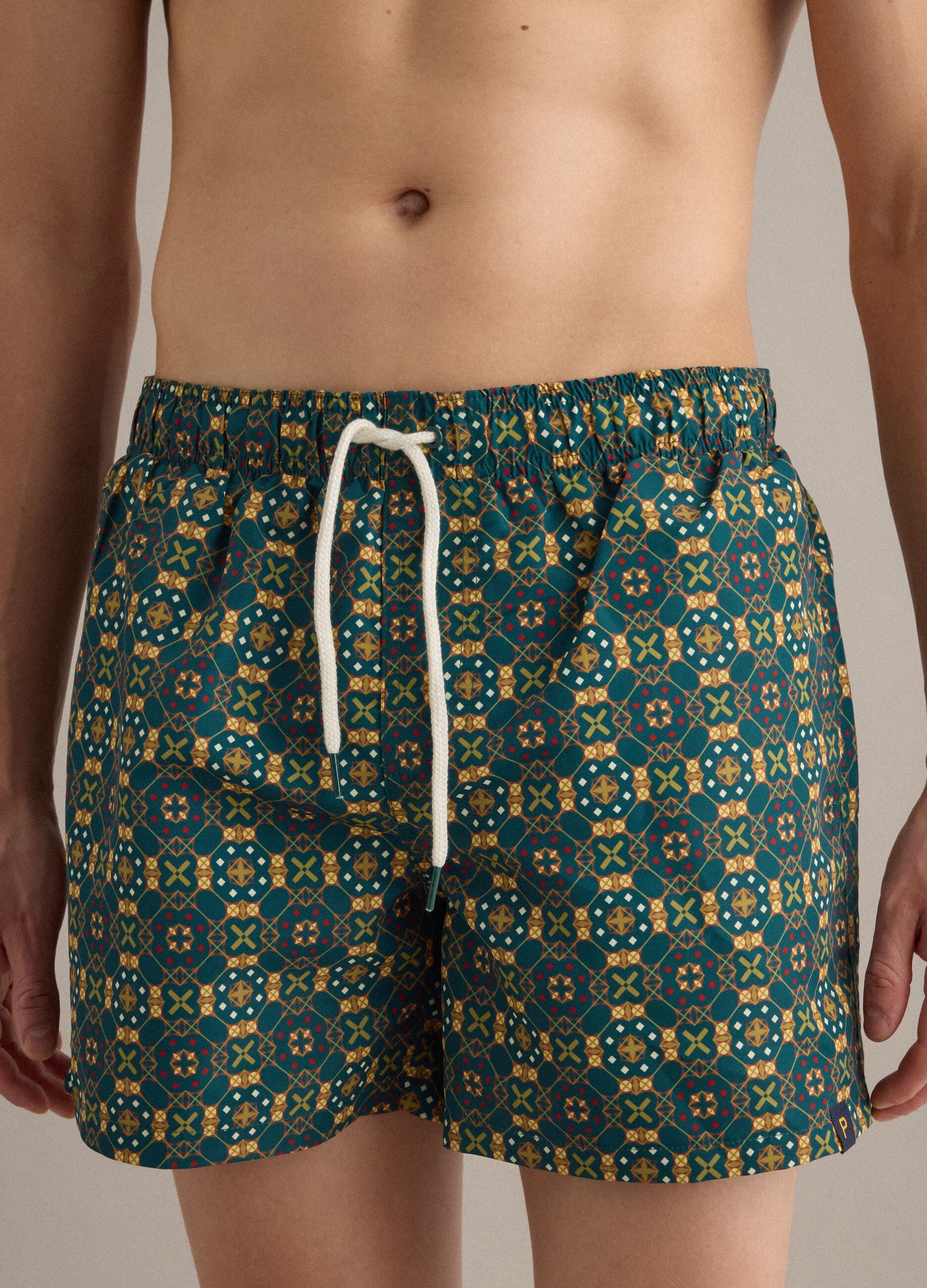 Green patterned swim shorts with elasticated waist