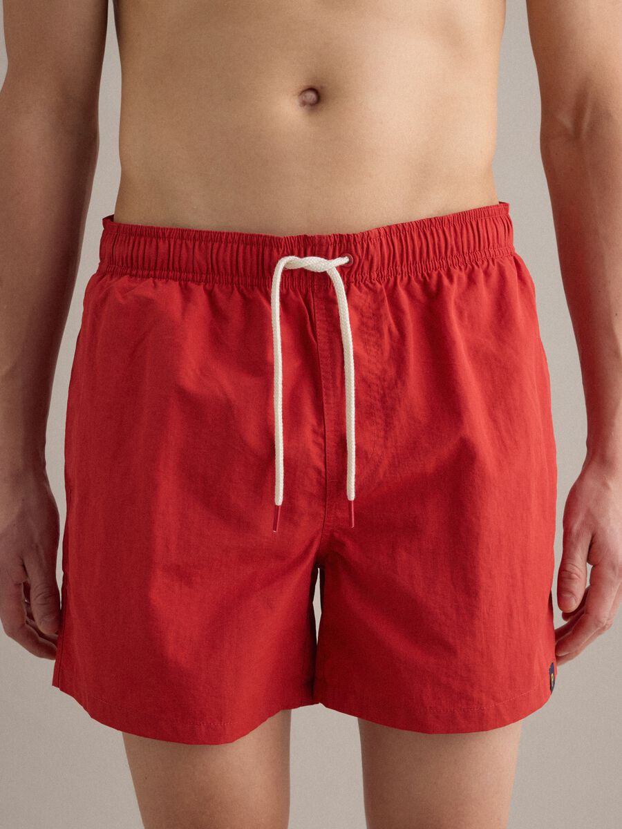 Red swim shorts with elasticated waistband and drawstring_1