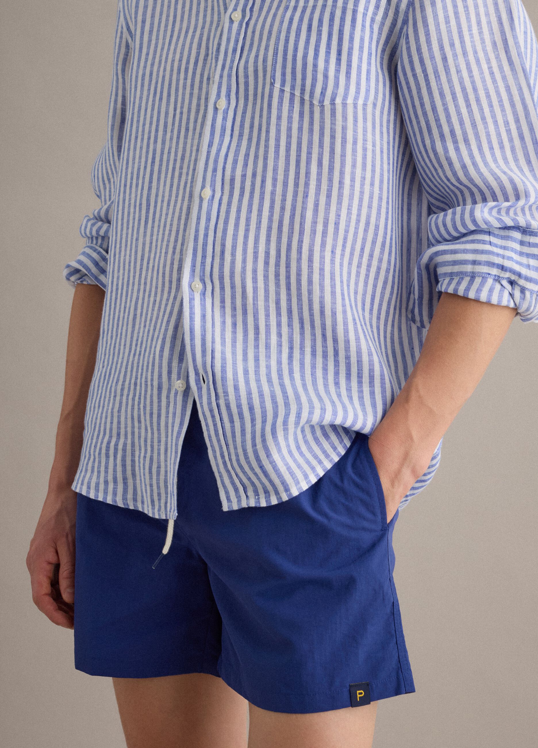 Blue swim shorts with elasticated waist and drawstring