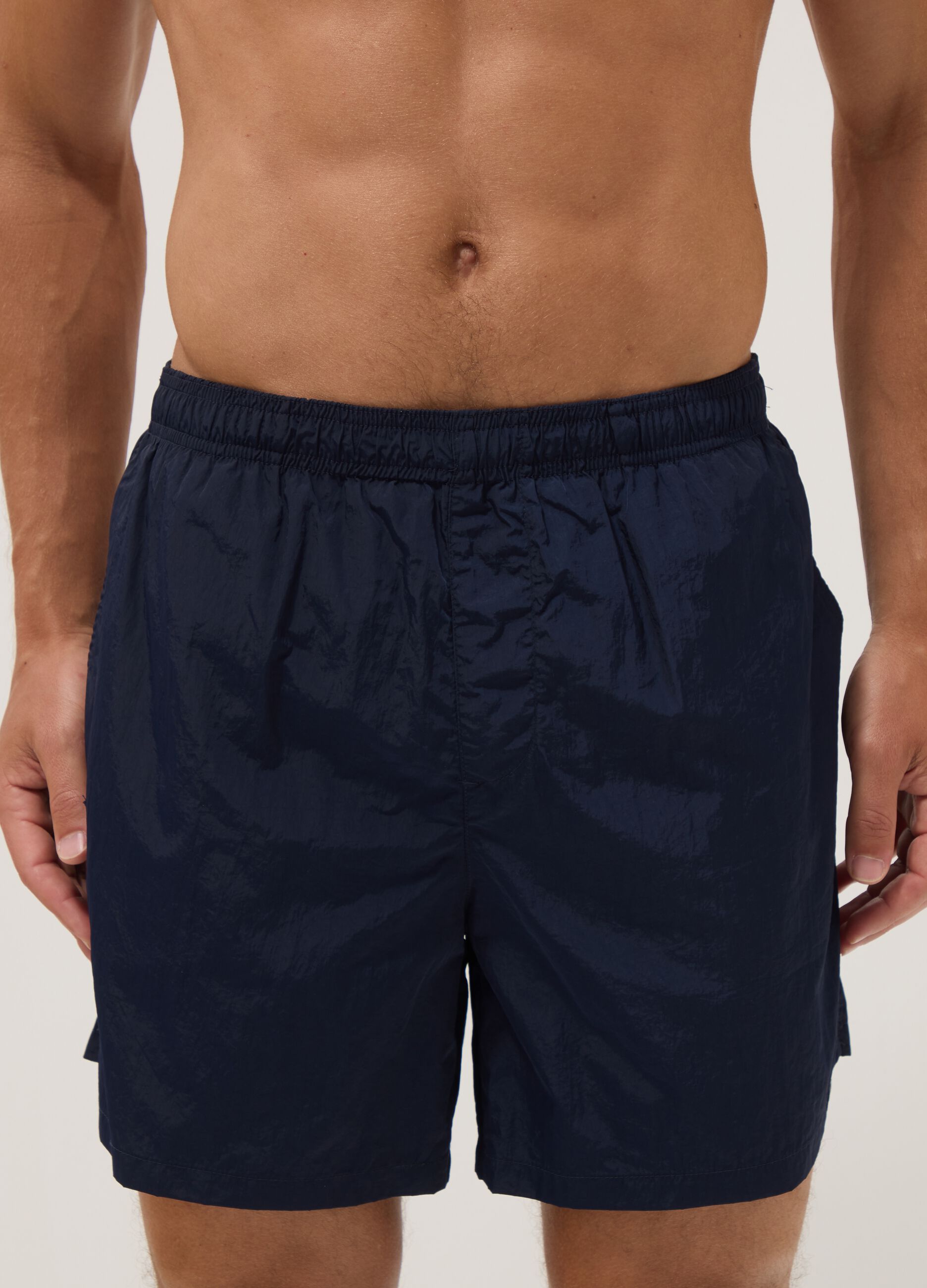 Blue swim shorts with elasticated waistband