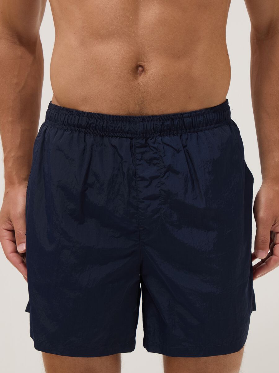 Blue swim shorts with elasticated waistband_1