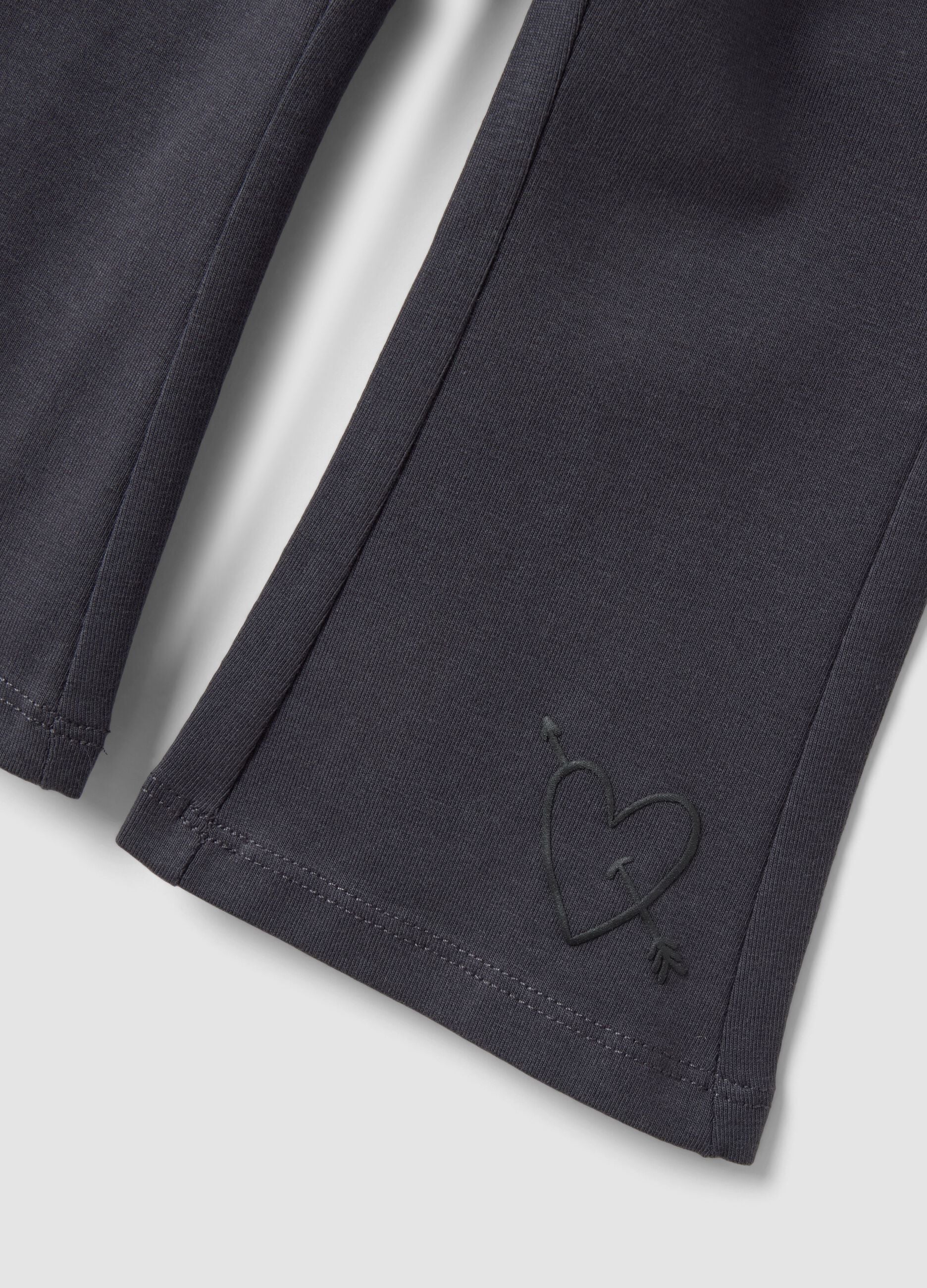 Black flared leggings in stretchy organic cotton blend with heart print for baby girl