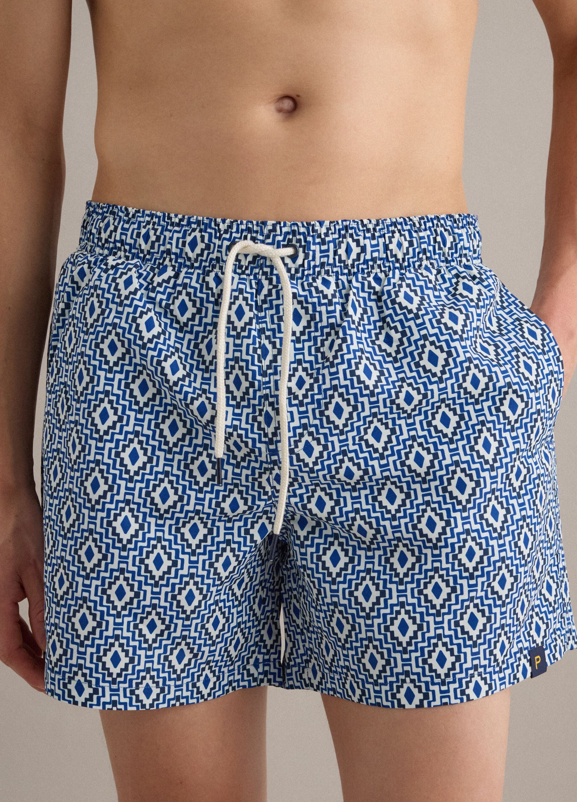 Blue swim shorts with geometric print