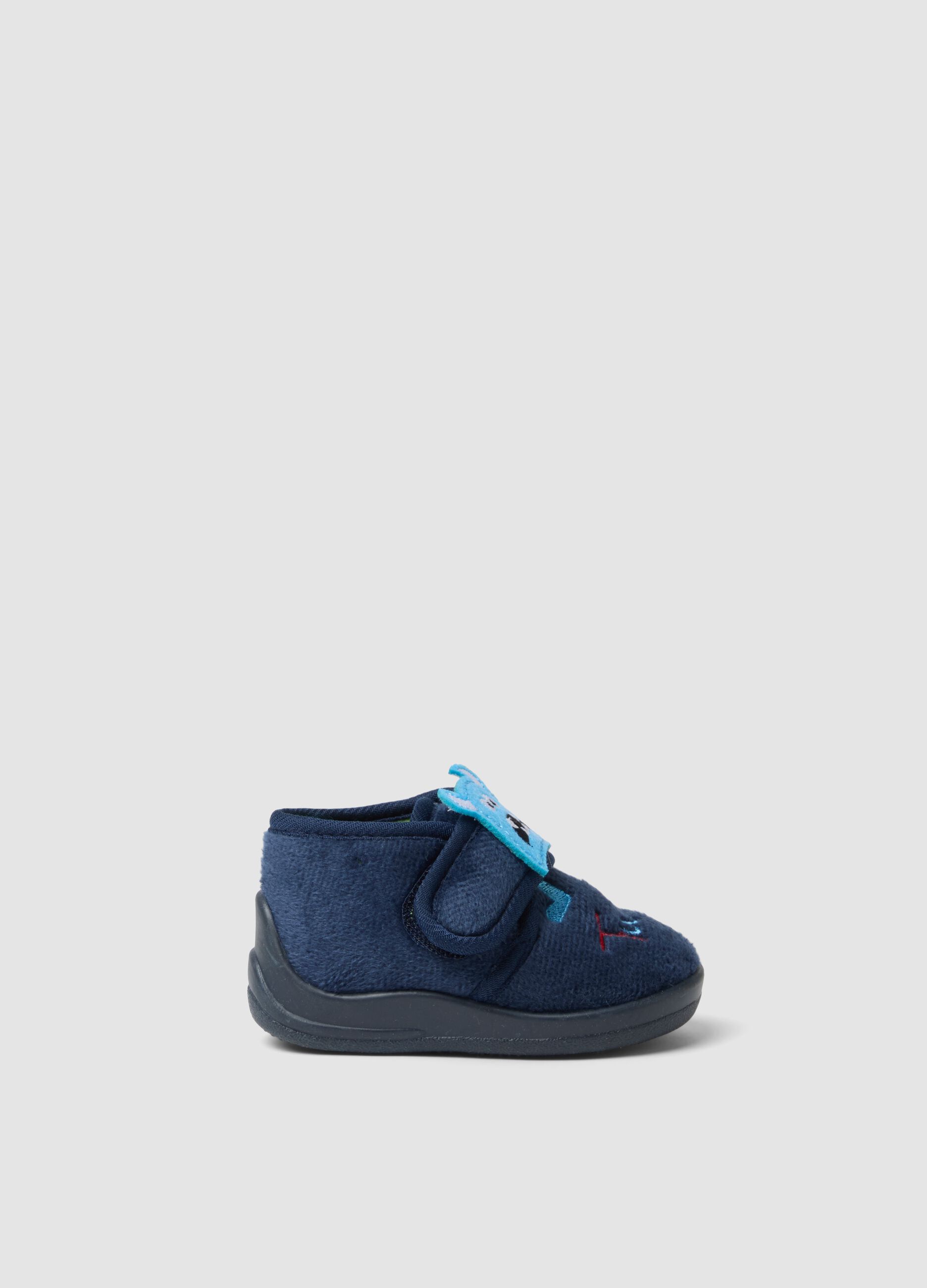 Blue slippers with embroidered monsters