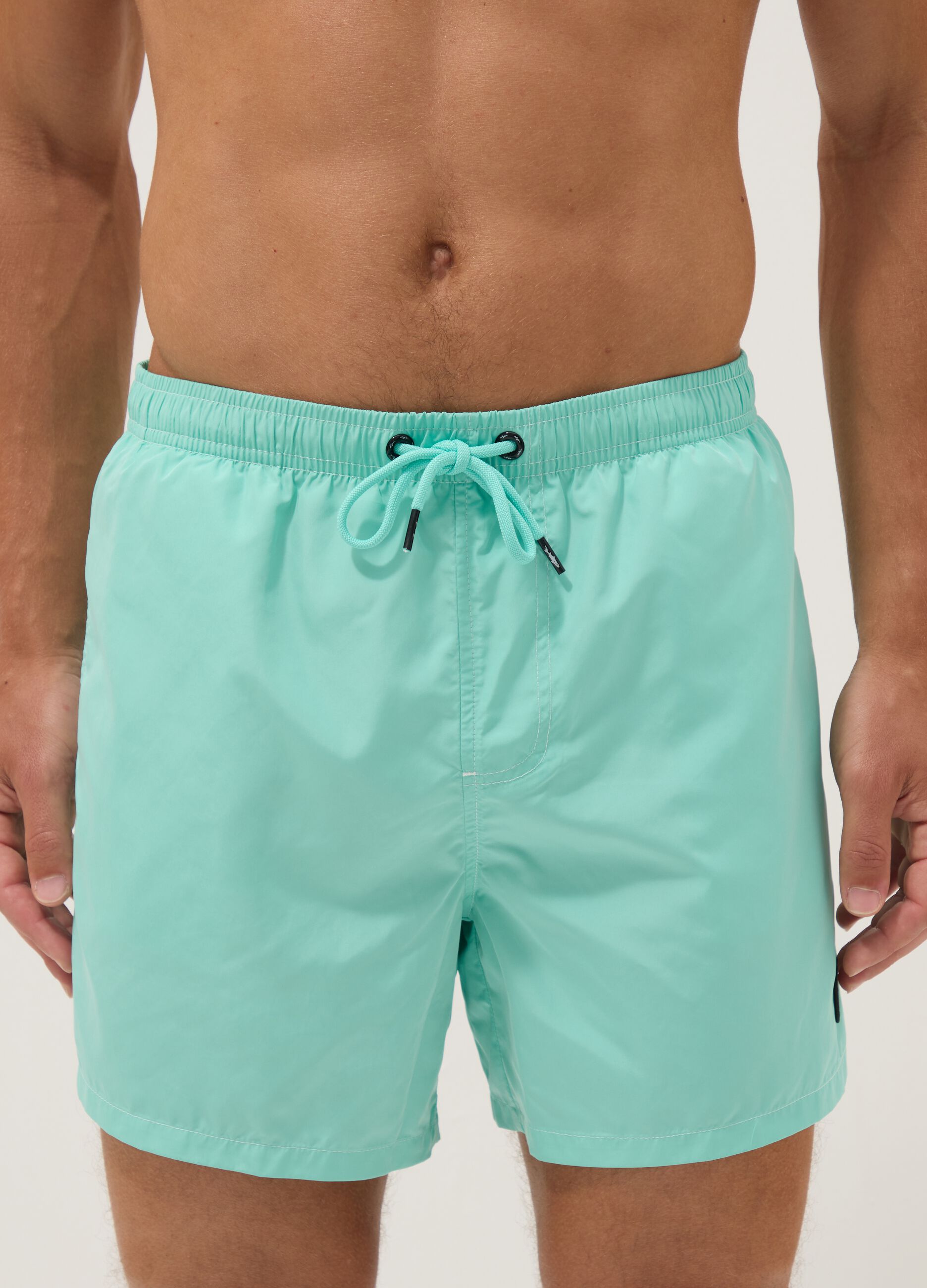 Light blue swim shorts with drawstring waist