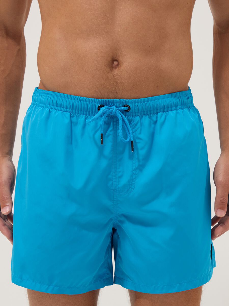 Blue swim shorts with elasticated waist and drawstring_1