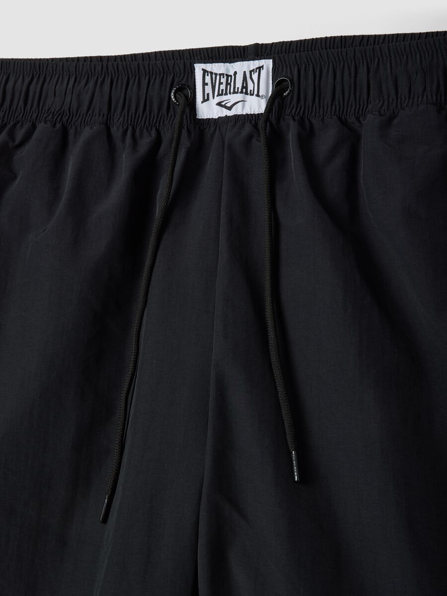Regular fit black sports shorts with white and orange details_5