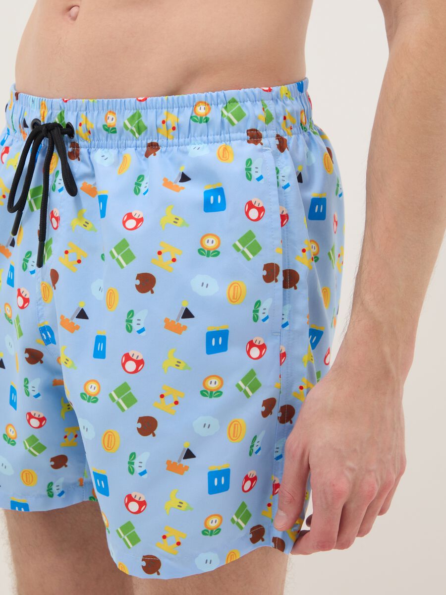 Blue swim shorts with Super Mario prints_3