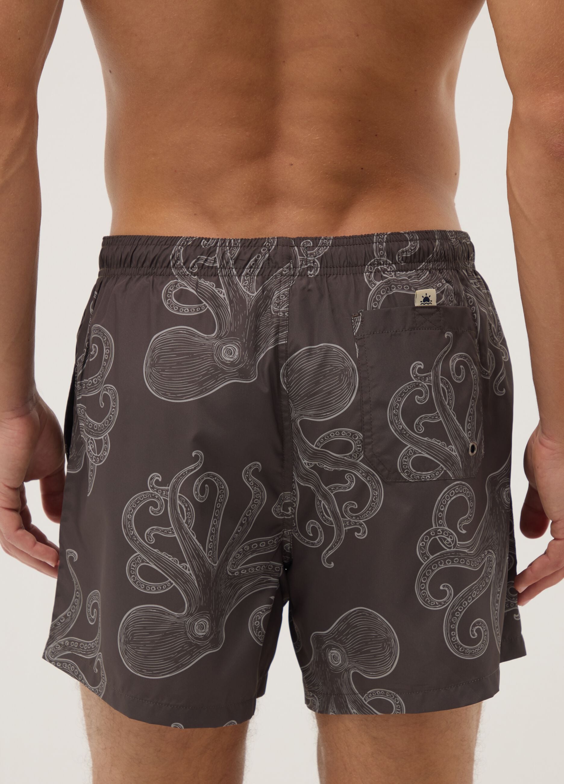 Brown swim shorts with all-over print
