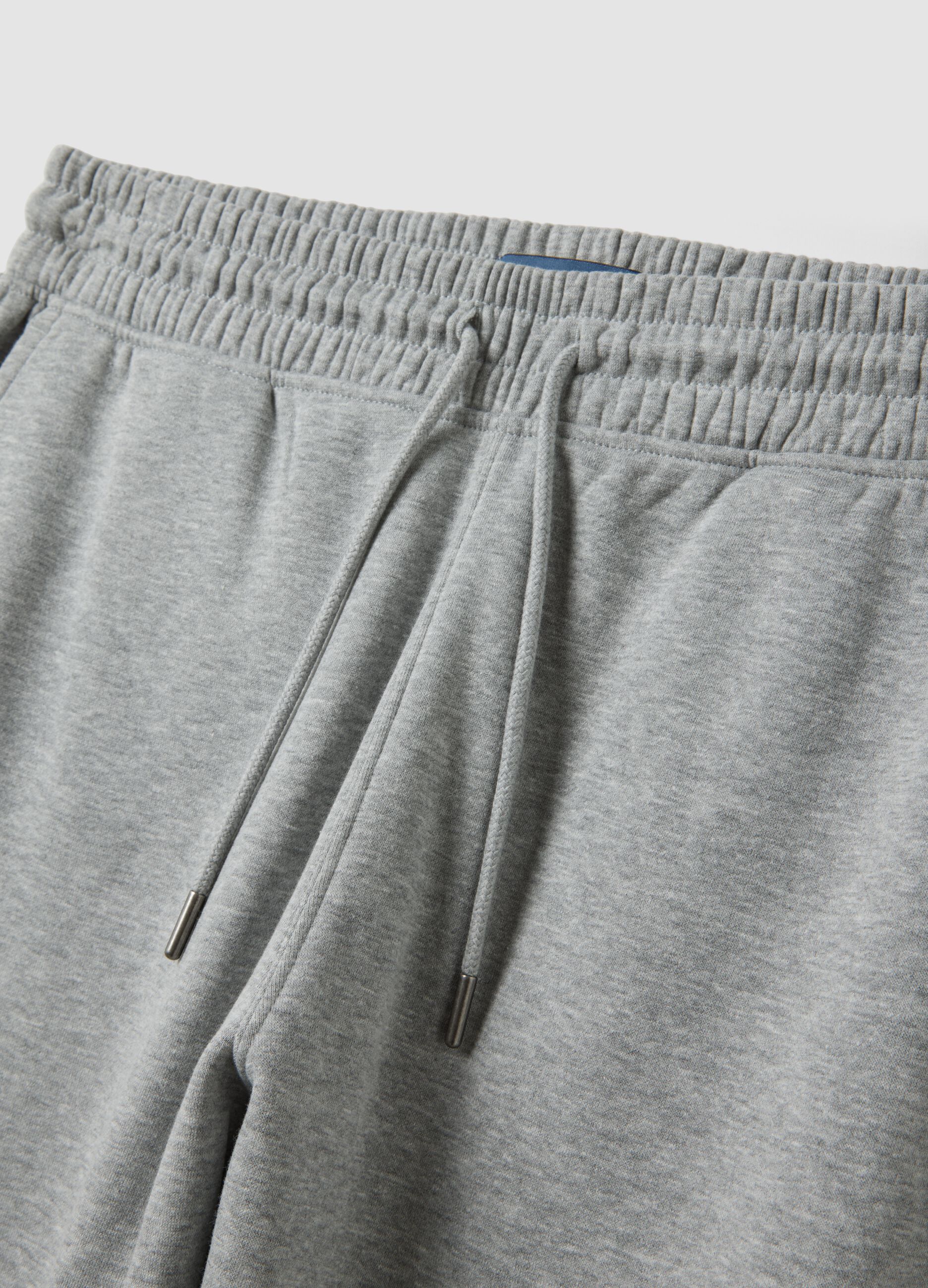 Grey cotton-blend joggers with cuffed hems and drawstring waist