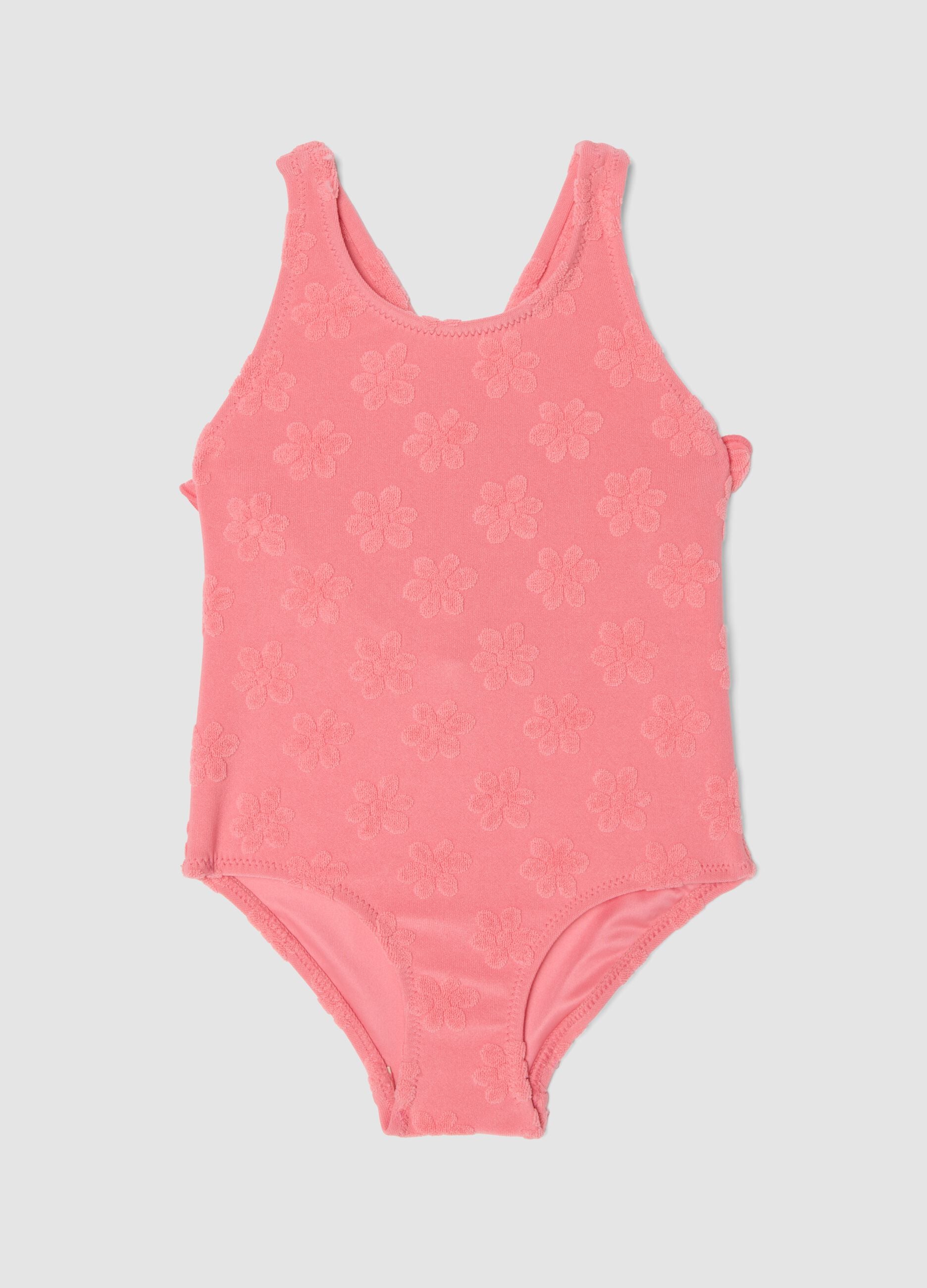 Pink stretch-fabric one-piece swimsuit for baby girls with floral detailing