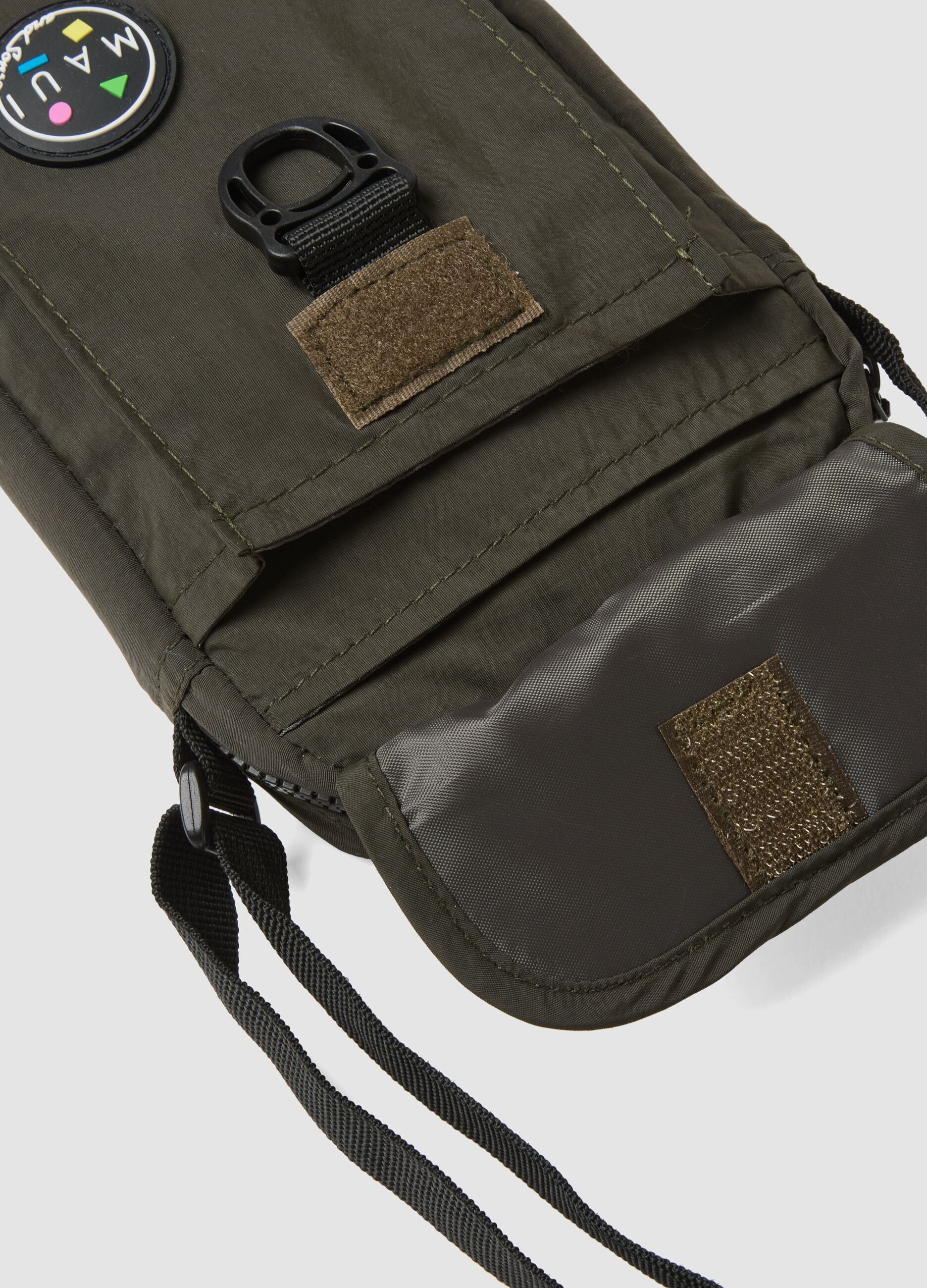 Green crossbody bag with zip closure and adjustable strap