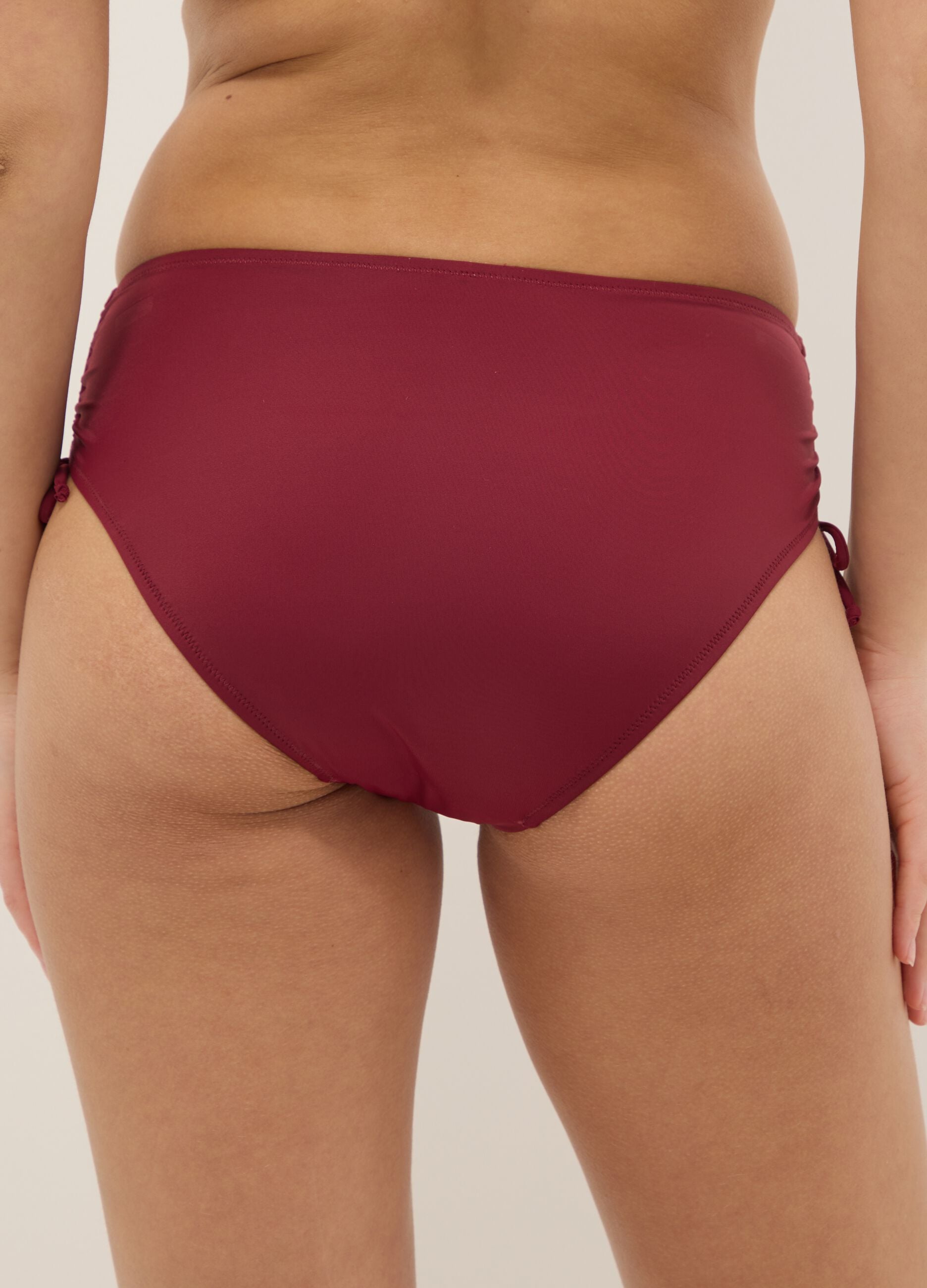 Red stretch bikini bottoms with ruched side detailing