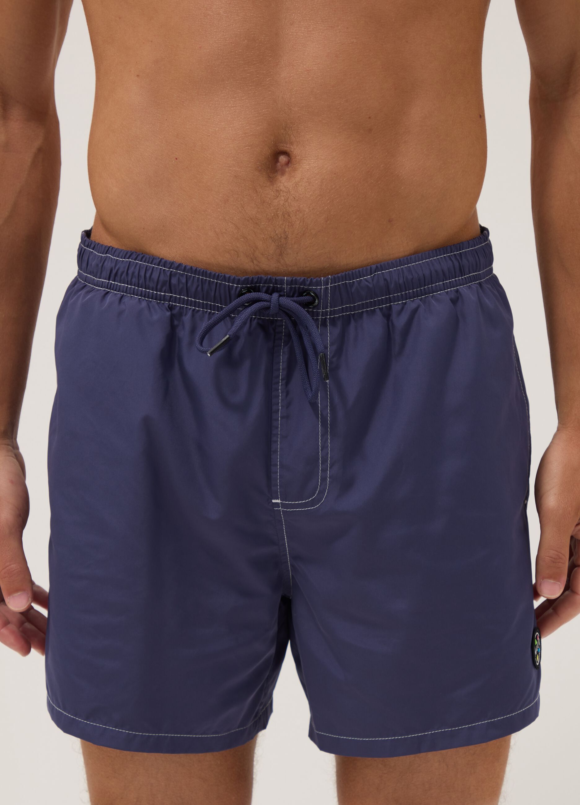 Blue swim shorts with drawstring waist