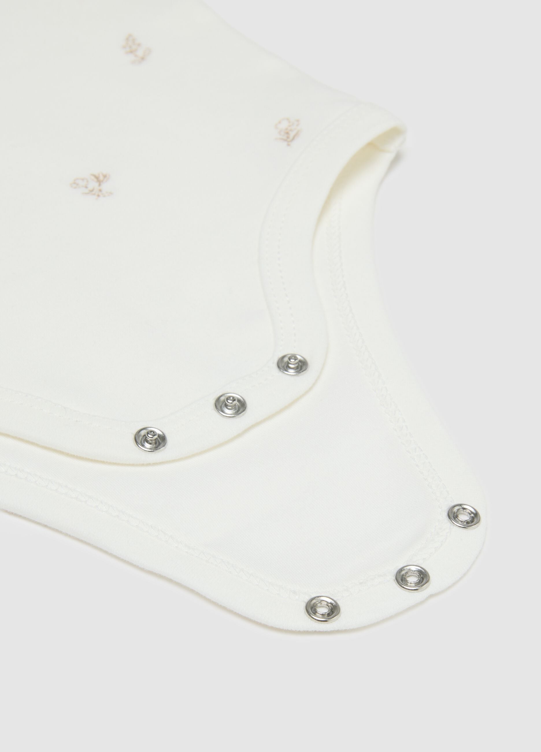 White baby girl's bodysuit in pure cotton with collar and embroidery
