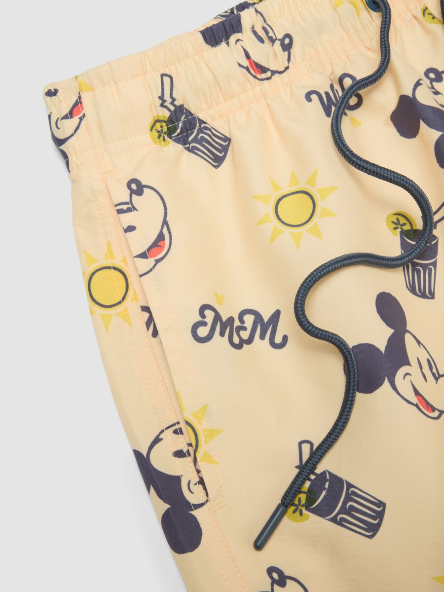 Orange swim trunks with Mickey Mouse prints_5