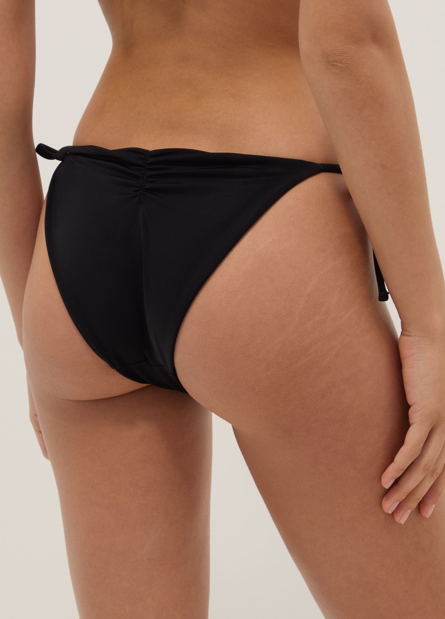 Black stretch bikini bottoms with decorative beads