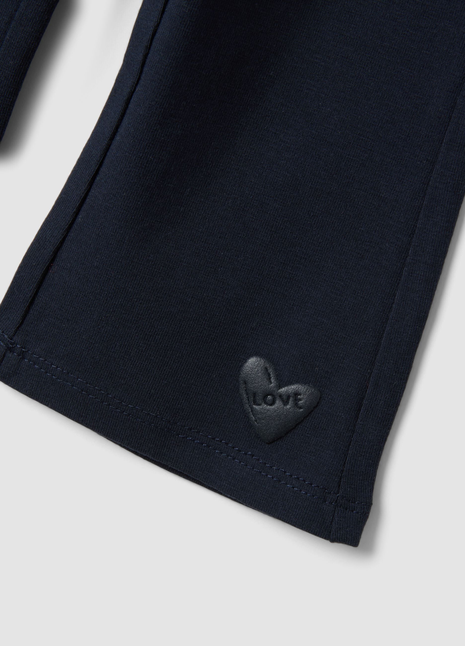 Blue flared leggings in stretchy organic cotton with heart detail for baby girl