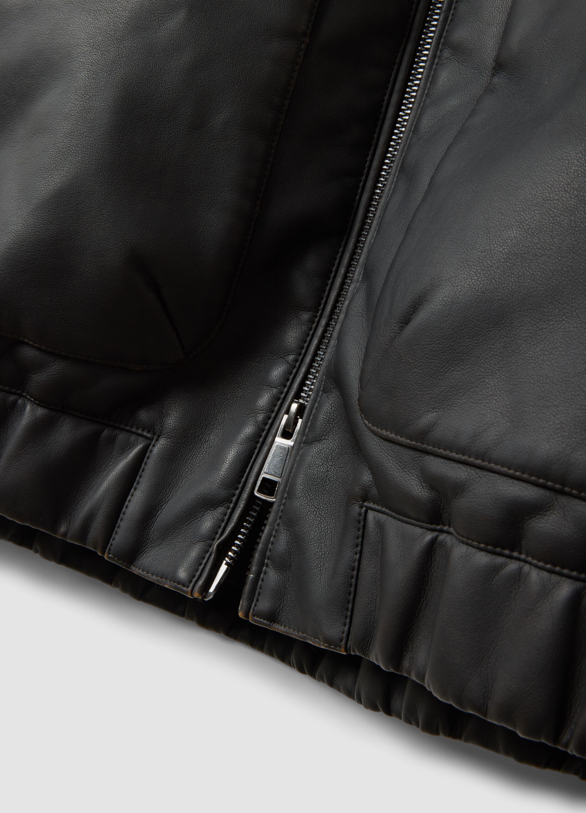 Black cropped jacket with zip and flap pockets, oversized fit