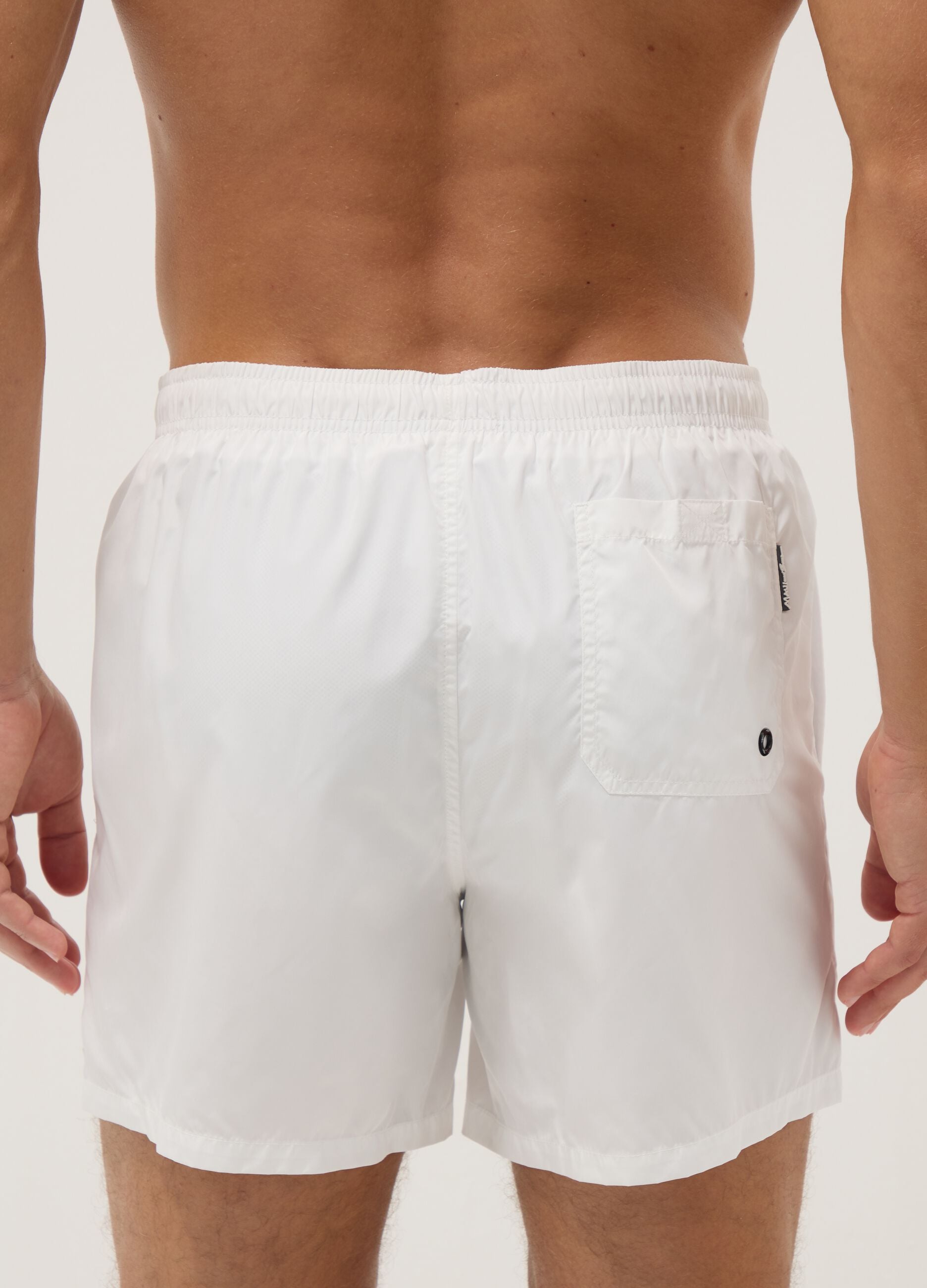 White swim shorts with elasticated waistband