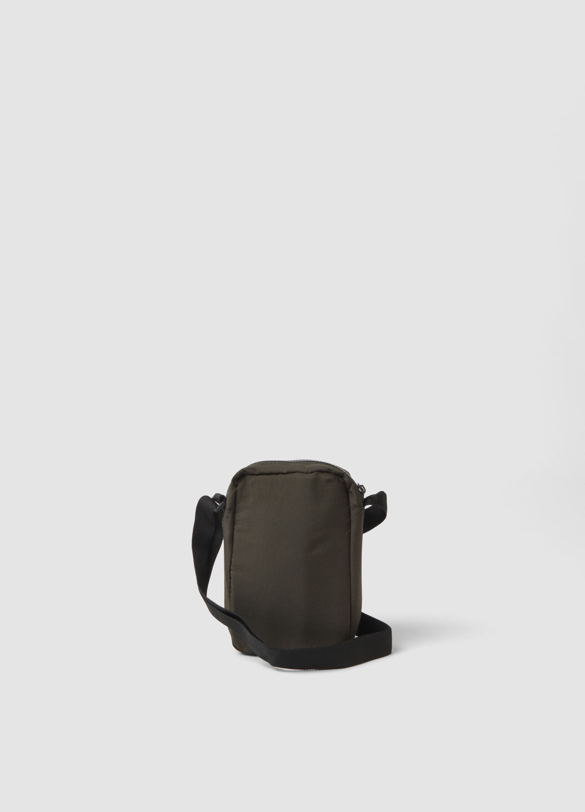 Green crossbody bag with zip closure and adjustable strap
